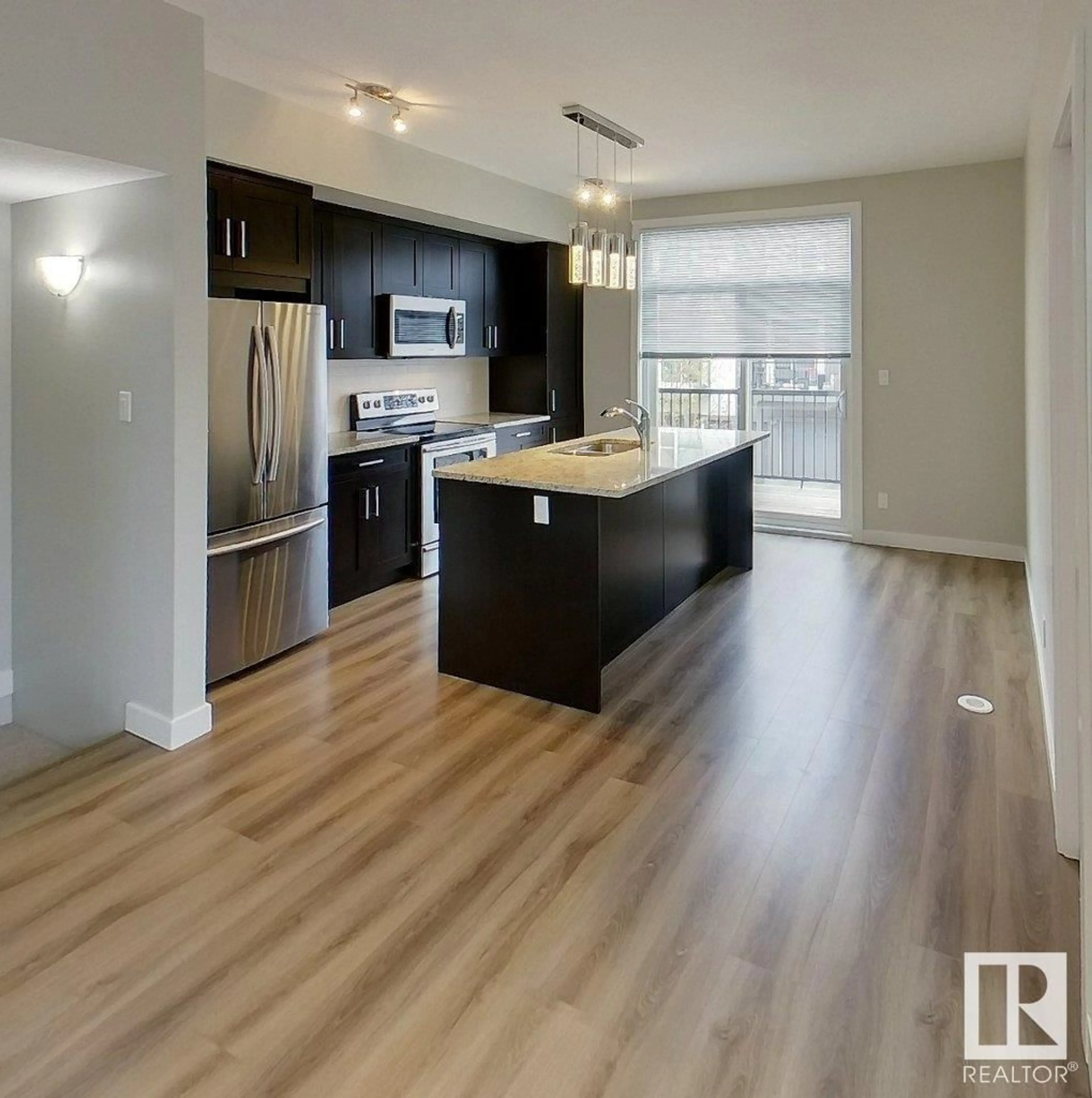 Open concept kitchen, wood/laminate floor for #102 - 2560 PEGASUS BV, Edmonton Alberta T5E6V4