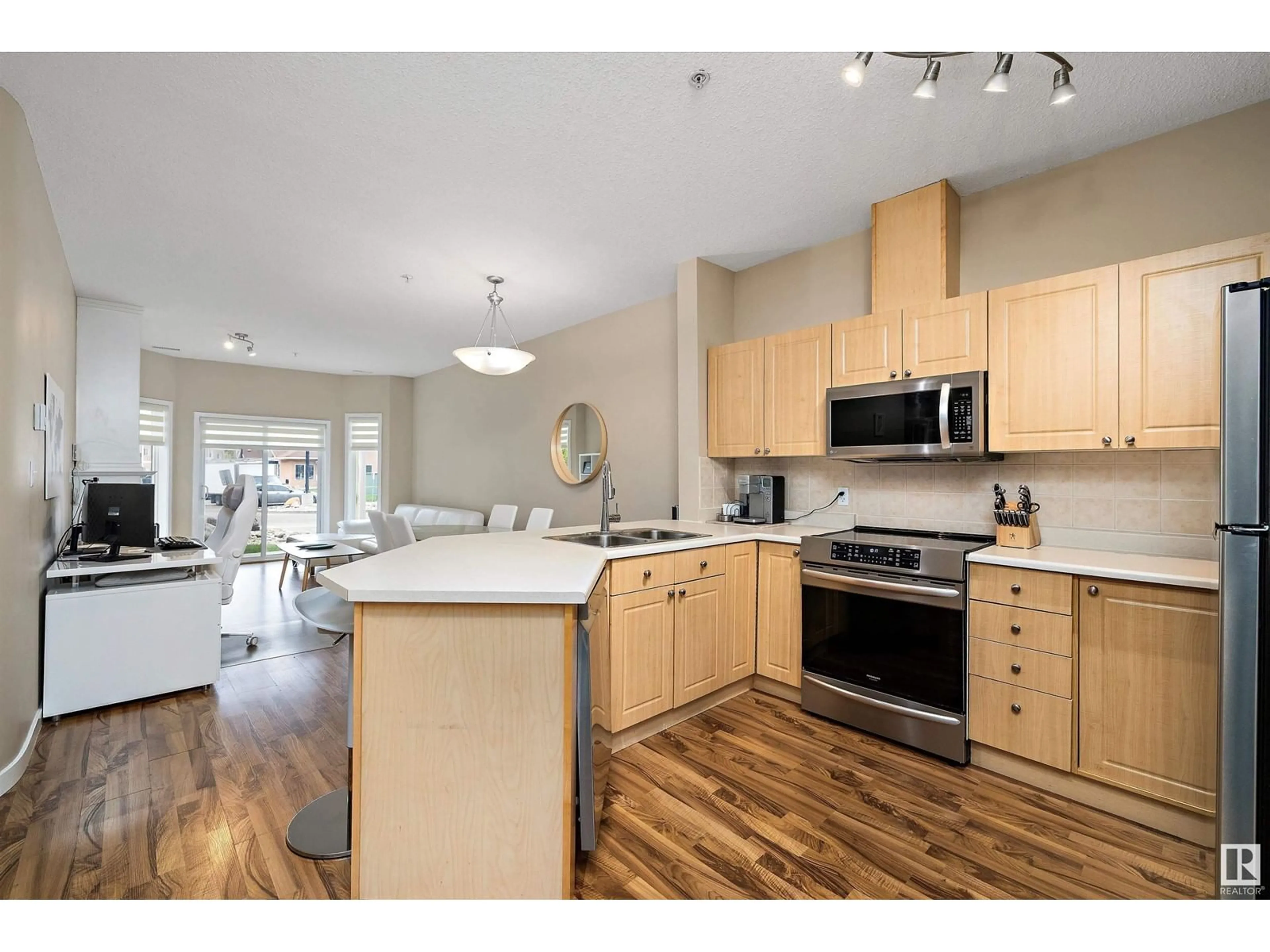 Open concept kitchen, wood/laminate floor for 126 - 4312 139 AV, Edmonton Alberta T5Y3J4