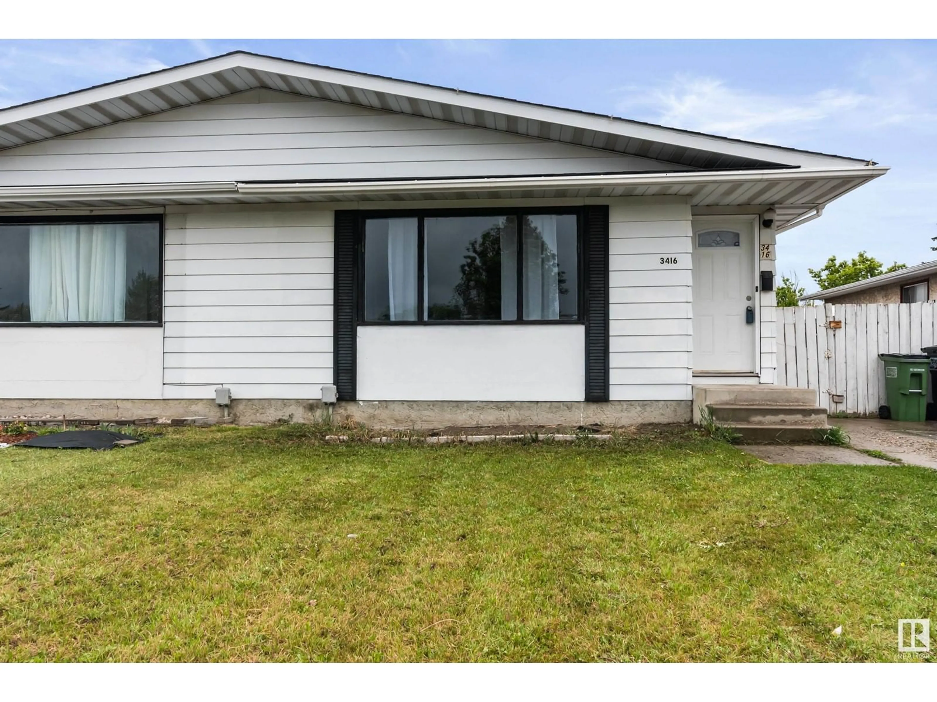 Home with vinyl exterior material, street for NW - 3416 135 AV, Edmonton Alberta T5A2V7