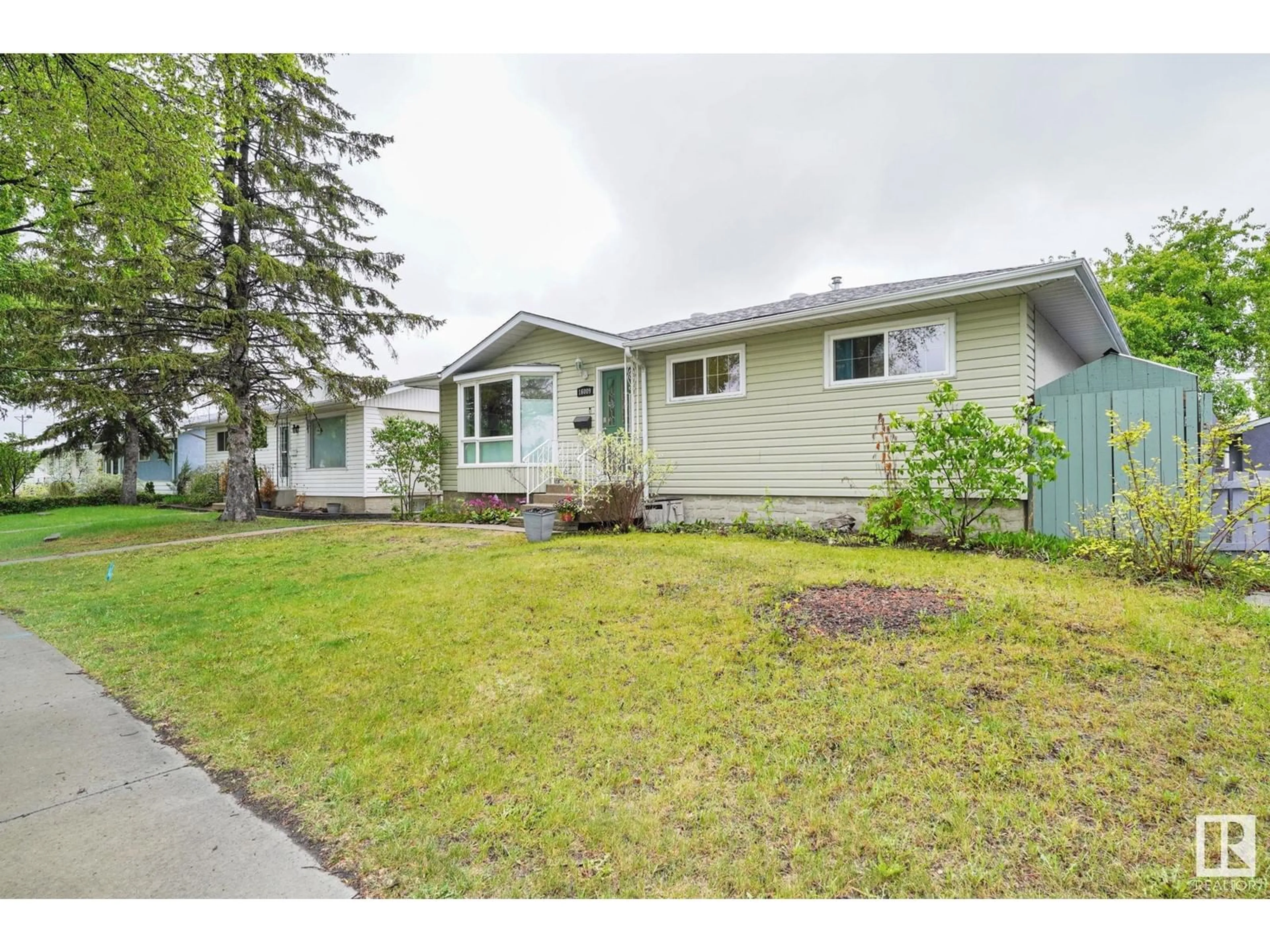 Home with vinyl exterior material, street for NW - 16009 92 AV, Edmonton Alberta T5R5C7