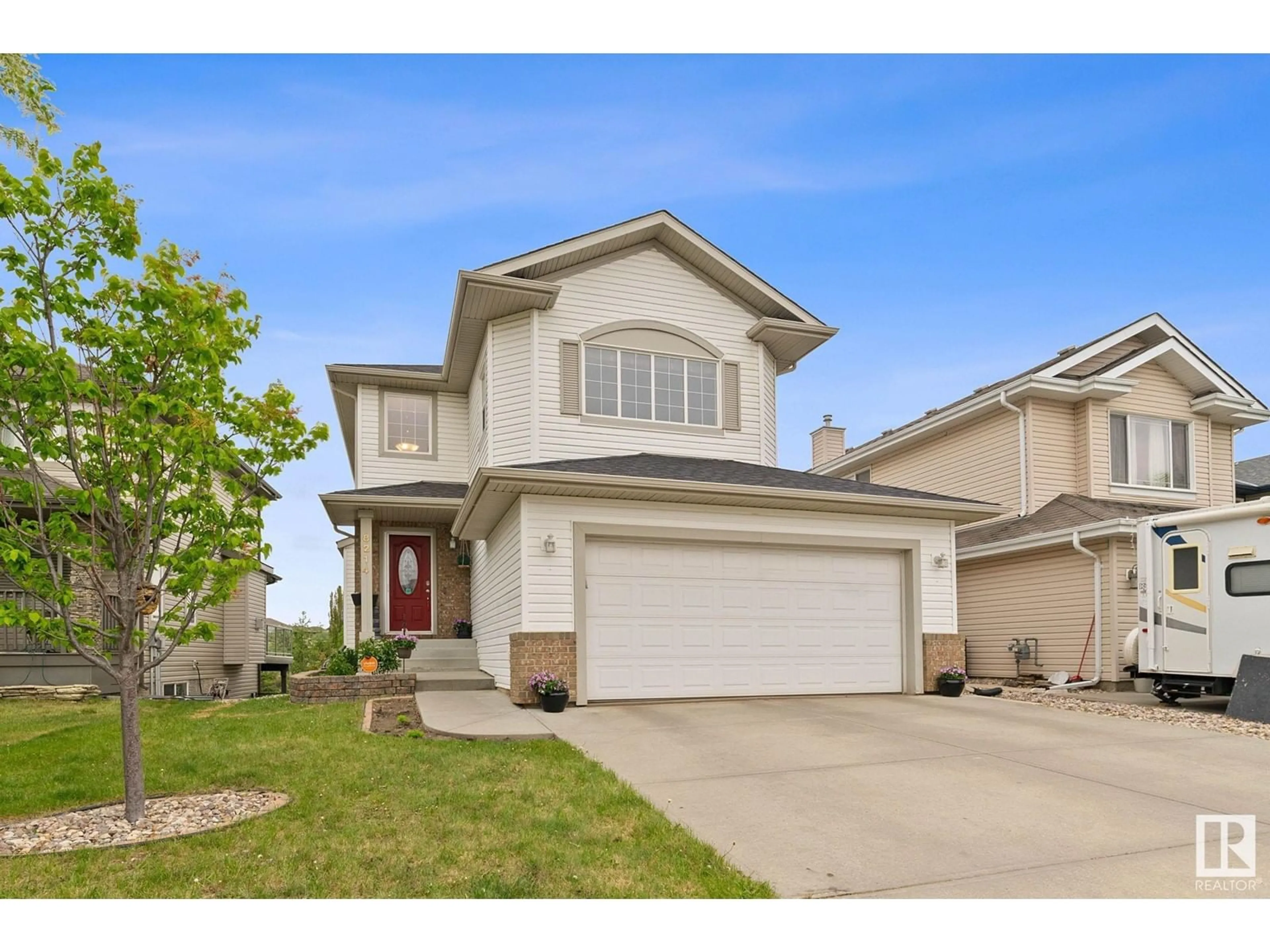 Home with vinyl exterior material, street for 8214 6 AV SW, Edmonton Alberta T6X1L6