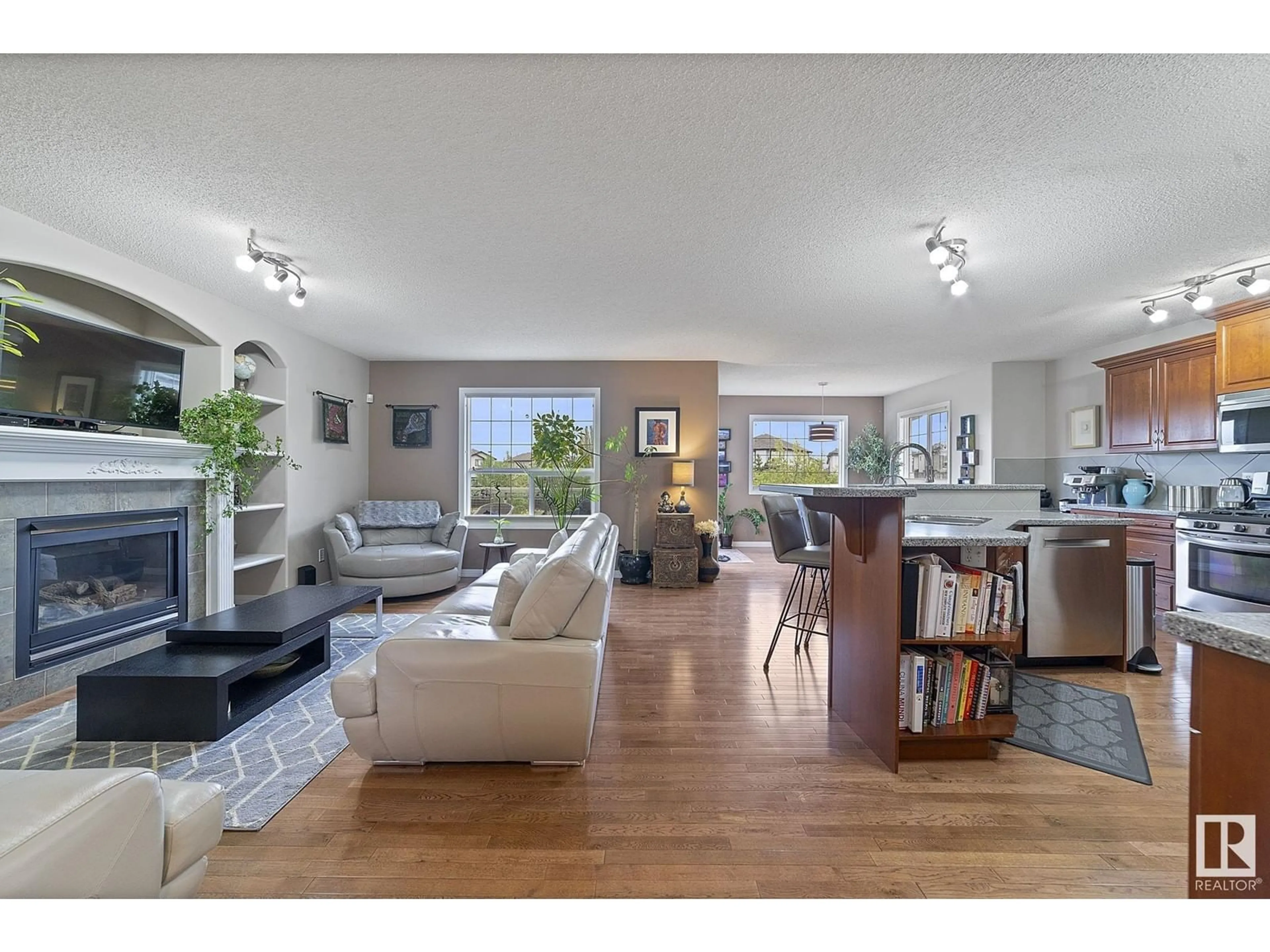 Living room with furniture, wood/laminate floor for 8214 6 AV SW, Edmonton Alberta T6X1L6