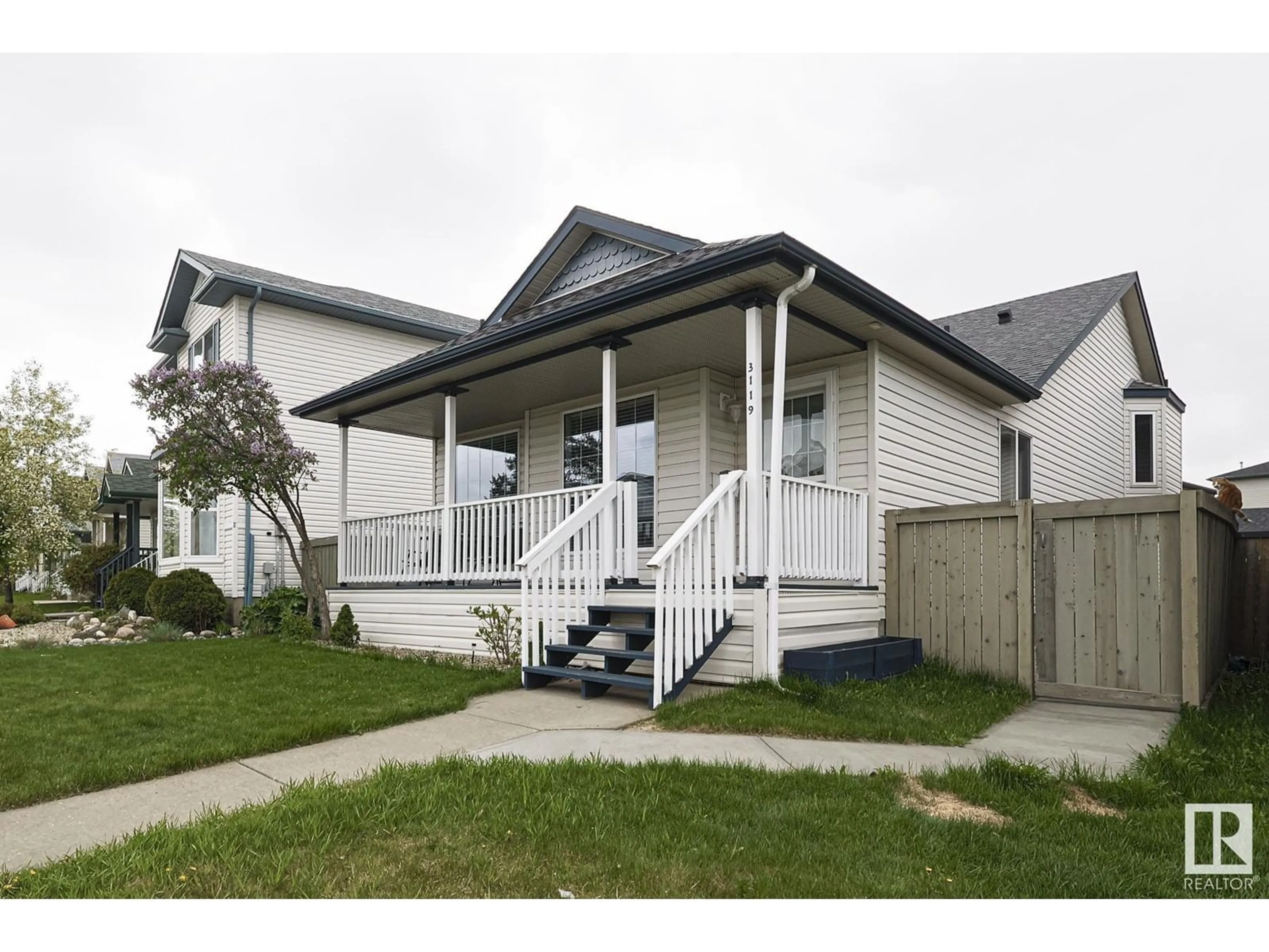 Home with vinyl exterior material, street for 3119 32 AV, Edmonton Alberta T6T1X3
