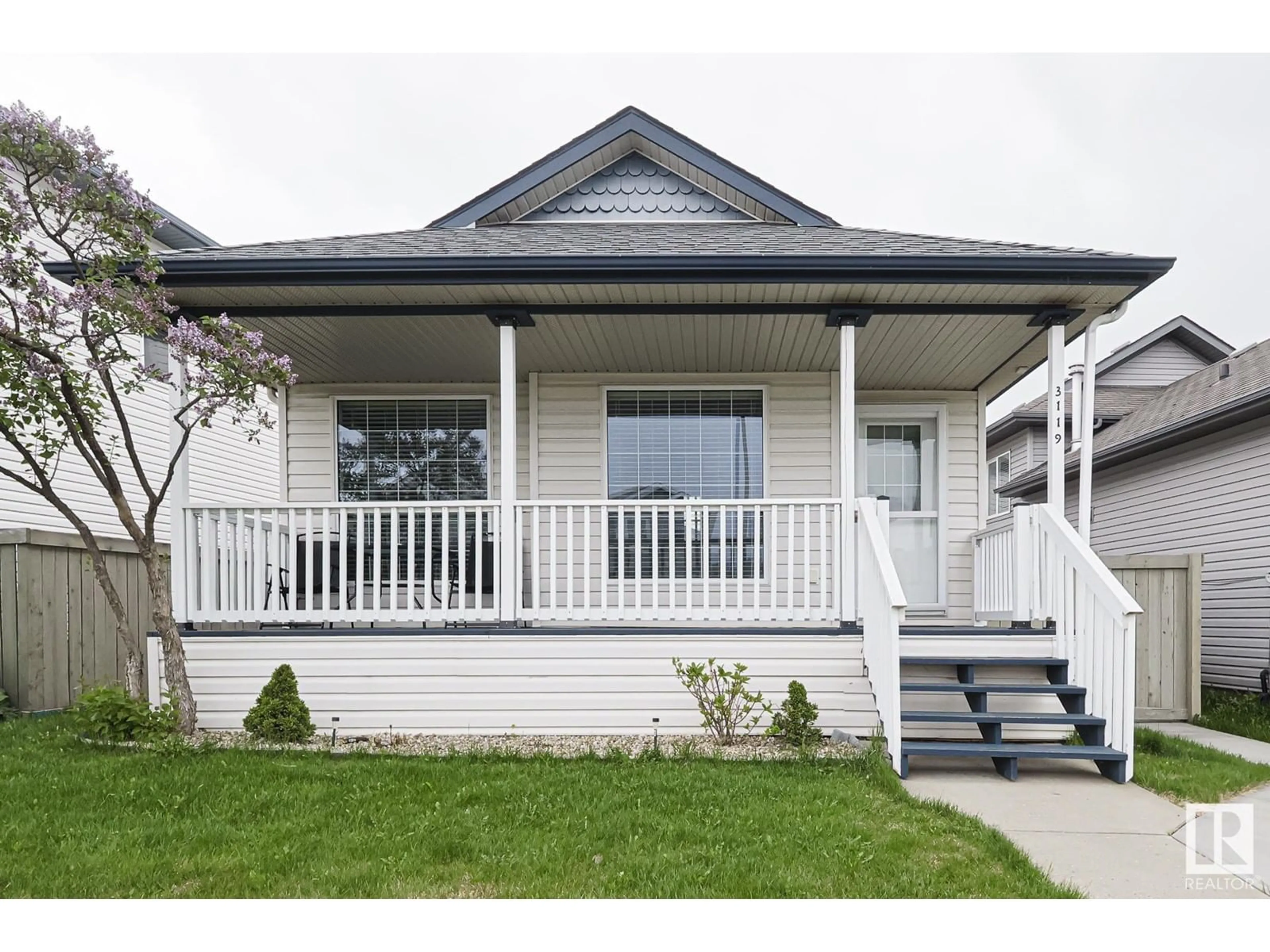 Home with vinyl exterior material, street for 3119 32 AV, Edmonton Alberta T6T1X3