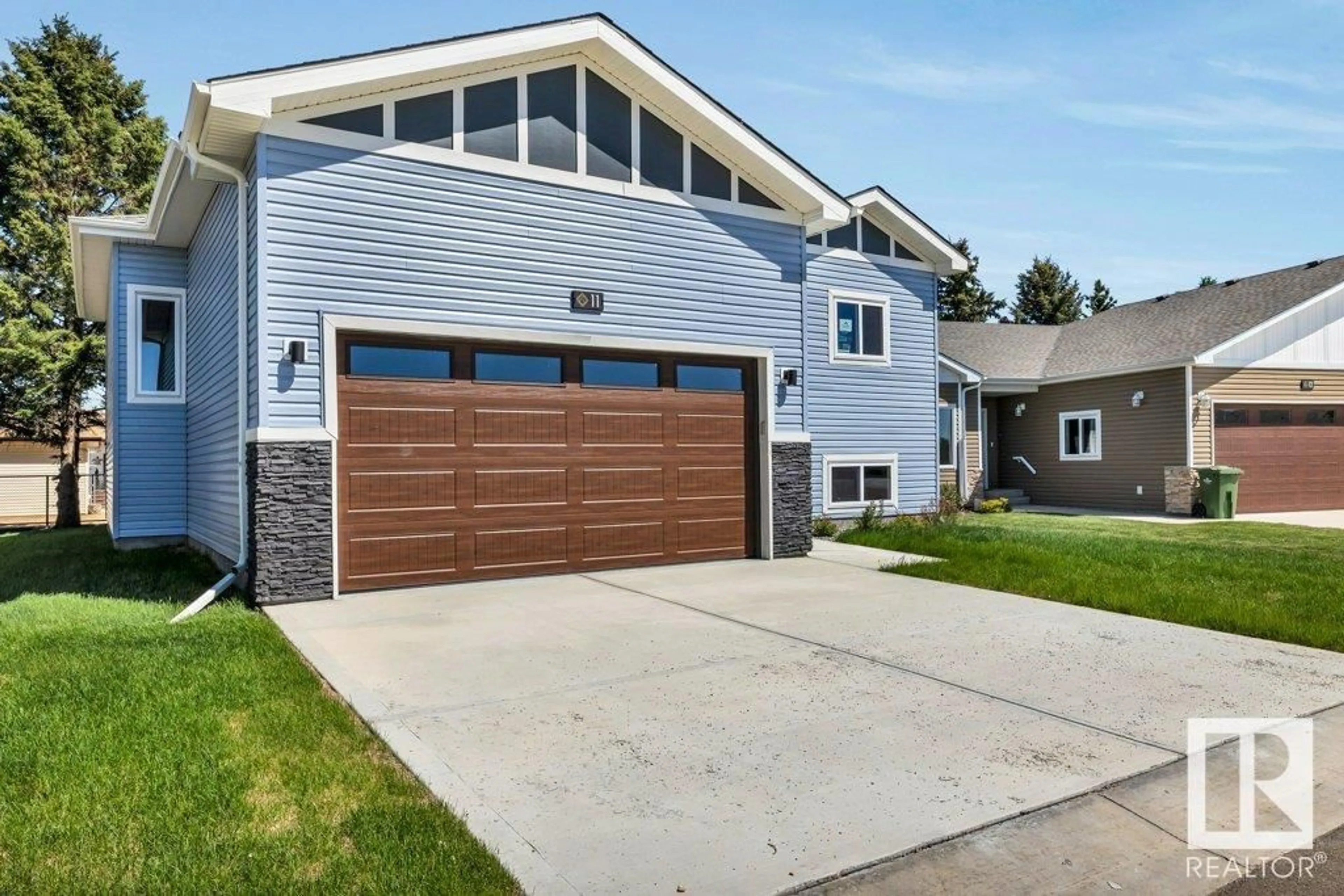 Home with vinyl exterior material, street for 11 - 6519 46 ST, Wetaskiwin Alberta T9A1Y5