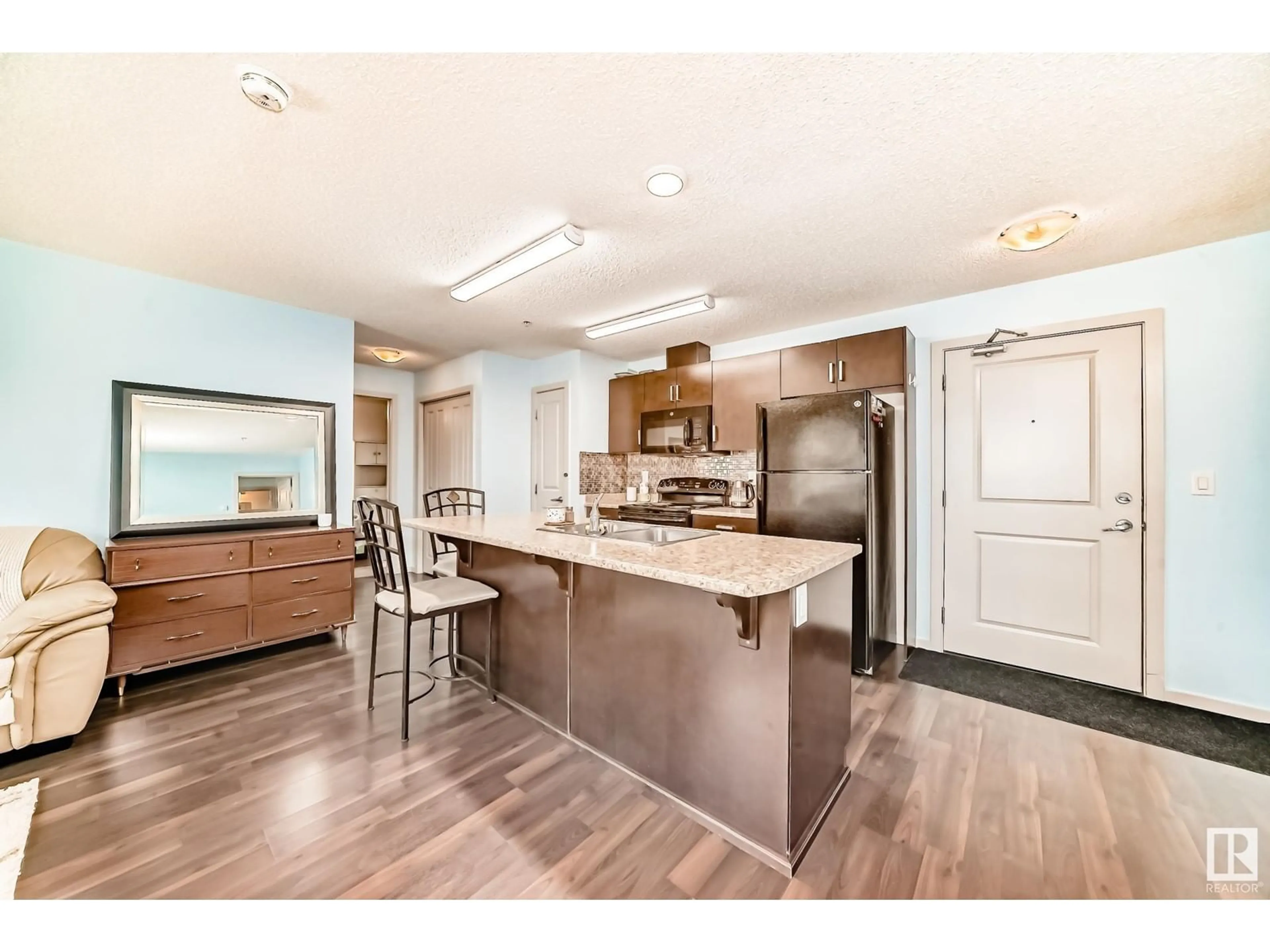 Open concept kitchen, wood/laminate floor for #122 - 5515 7 AV, Edmonton Alberta T6X2A8