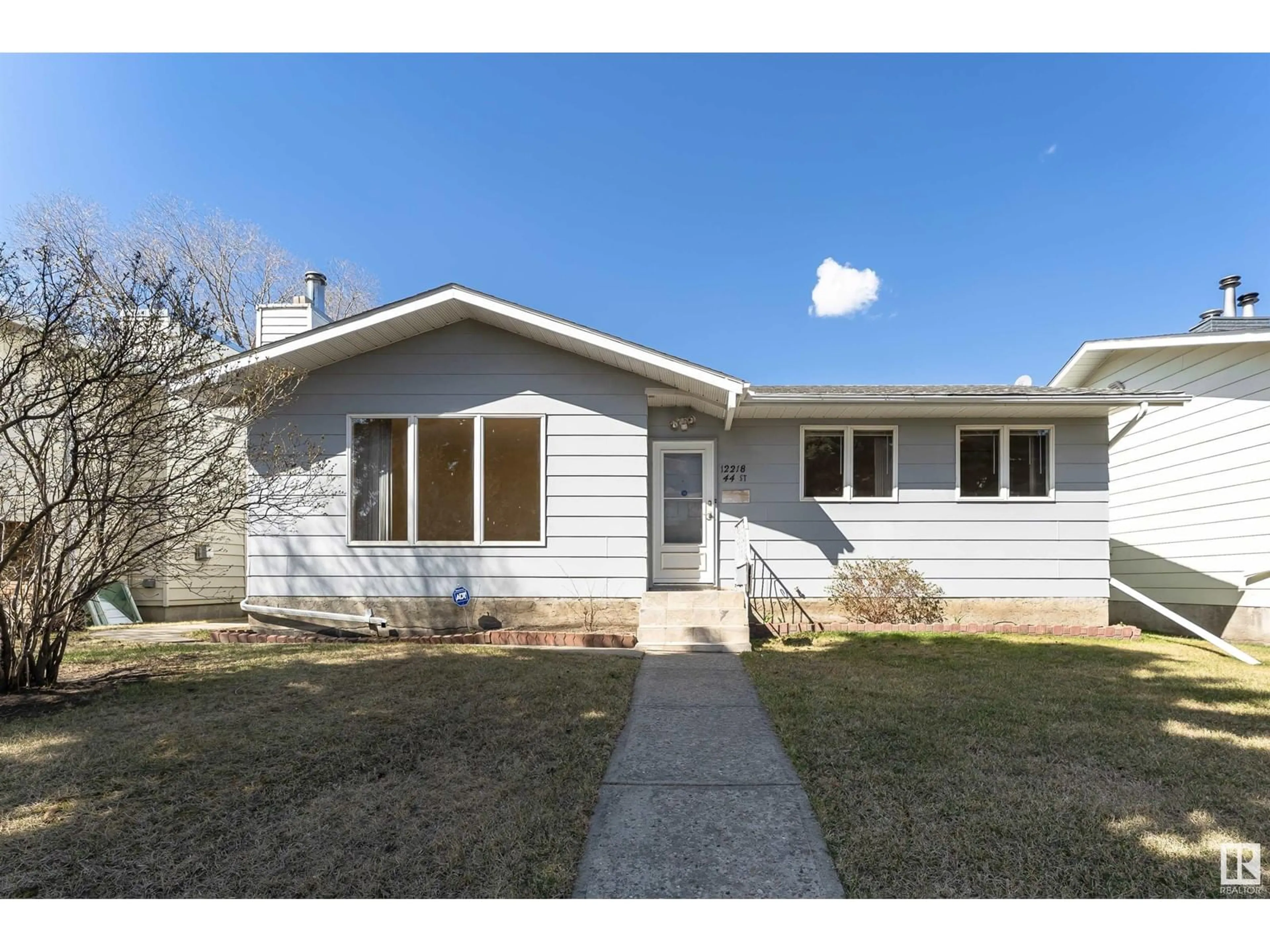 Home with vinyl exterior material, street for 12218 44 ST, Edmonton Alberta T5W4W8