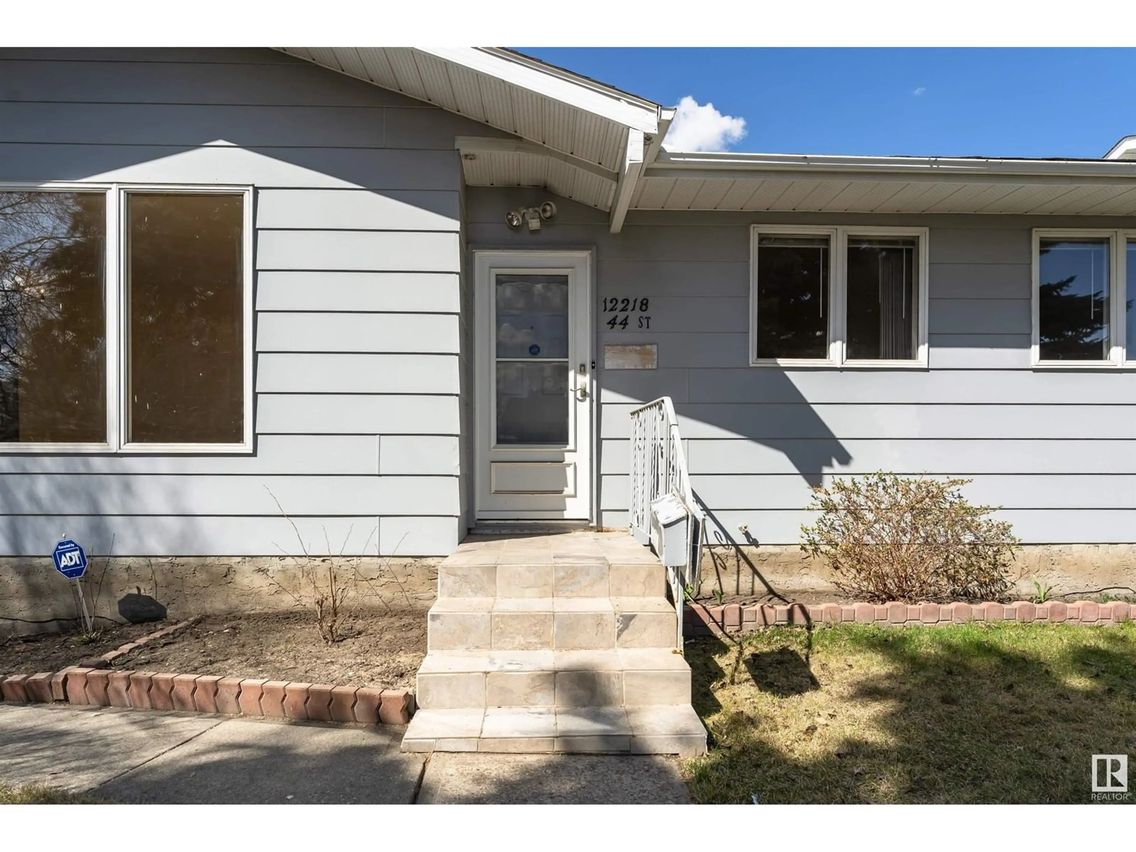 Home with vinyl exterior material, street for 12218 44 ST, Edmonton Alberta T5W4W8