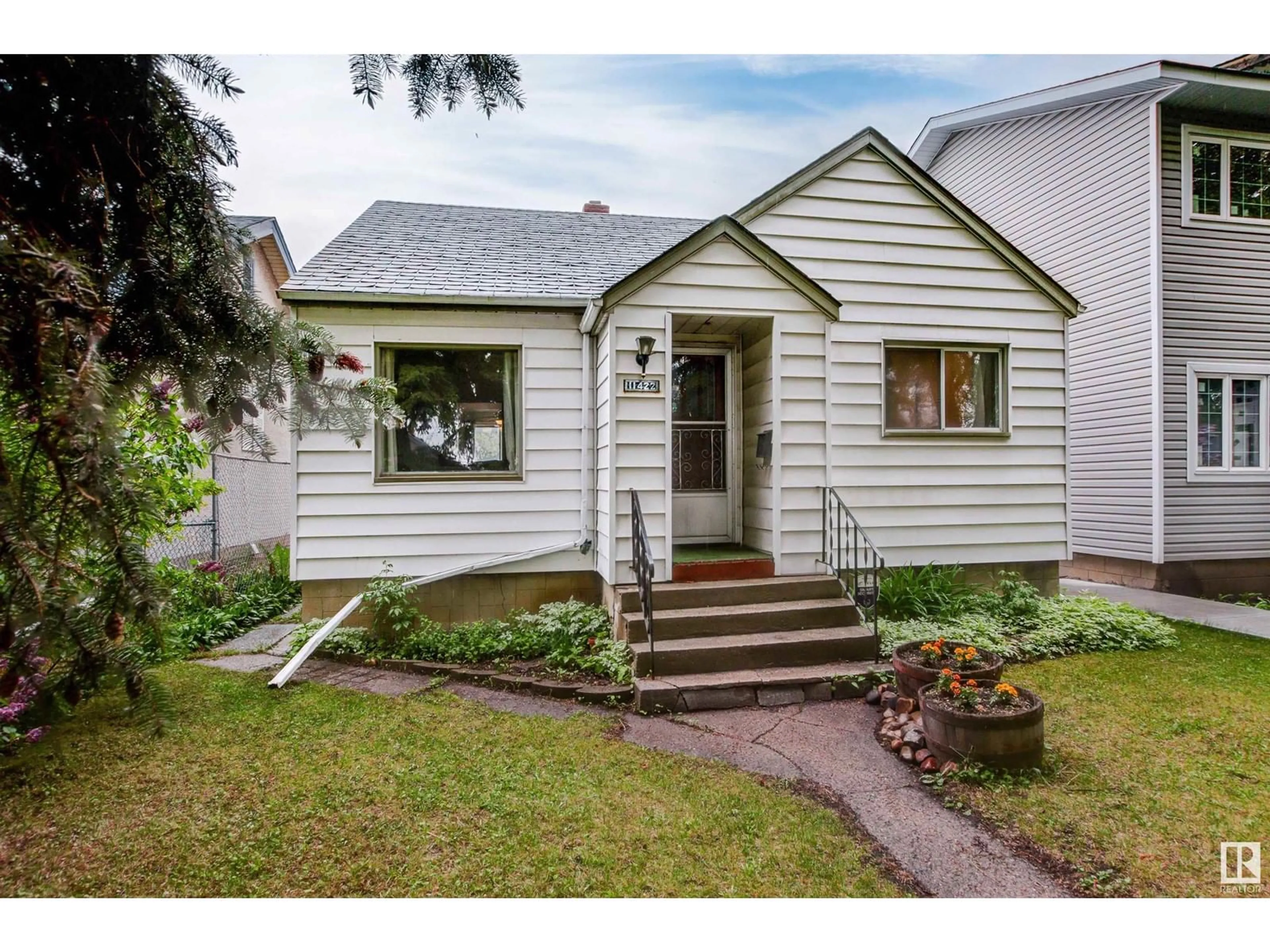Home with vinyl exterior material, street for 11422 83 ST, Edmonton Alberta T5B2Y3