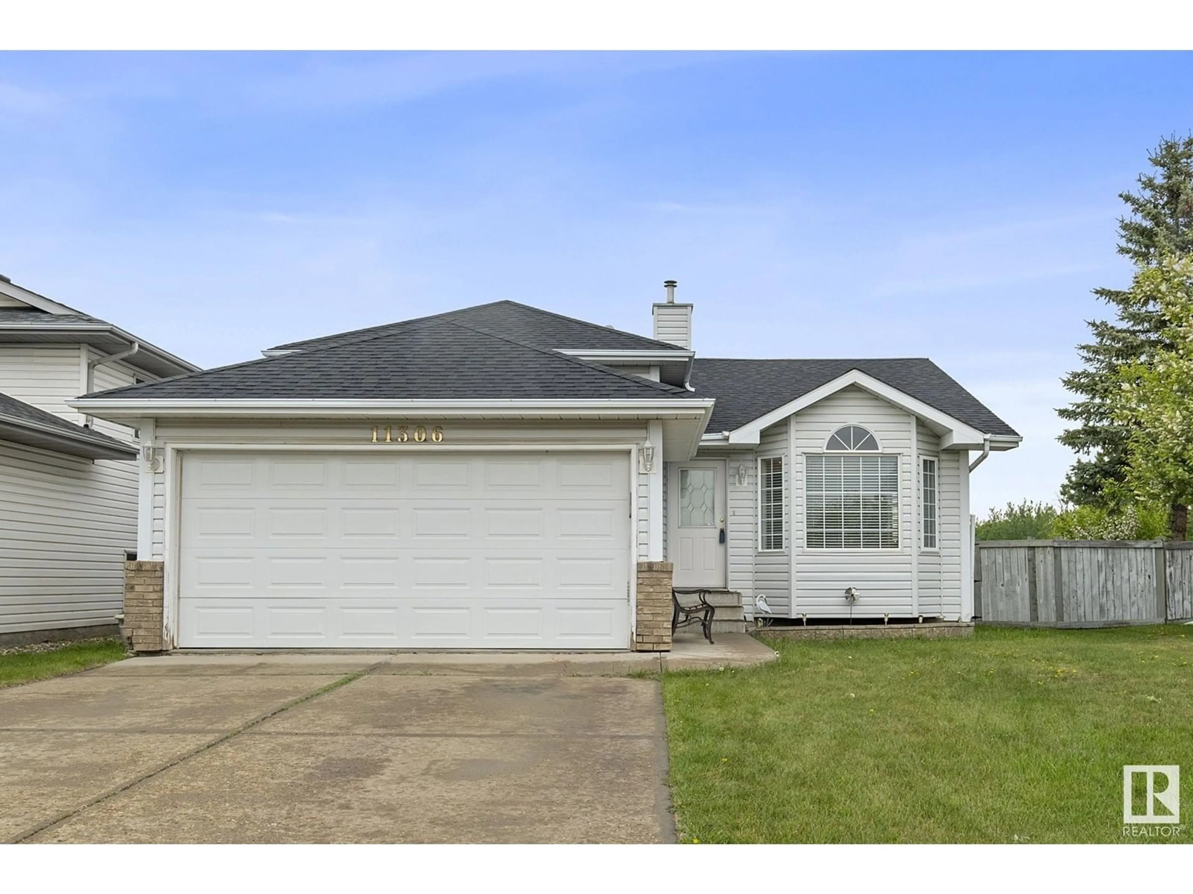 Home with vinyl exterior material, street for 11306 173 AV, Edmonton Alberta T5X5Y4