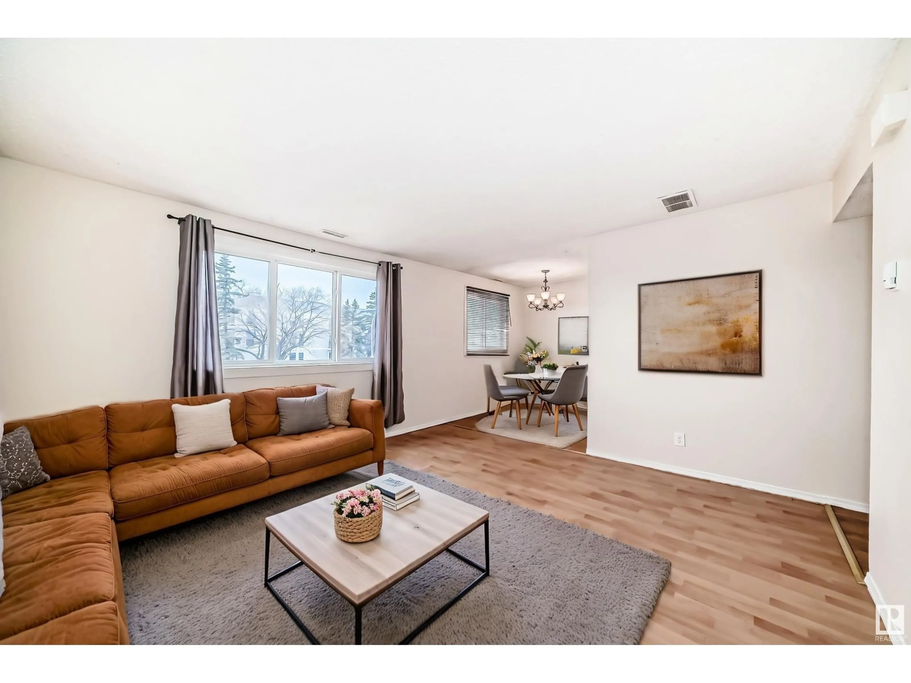Living room with furniture, wood/laminate floor for 8417 29 AV, Edmonton Alberta T6K3M8