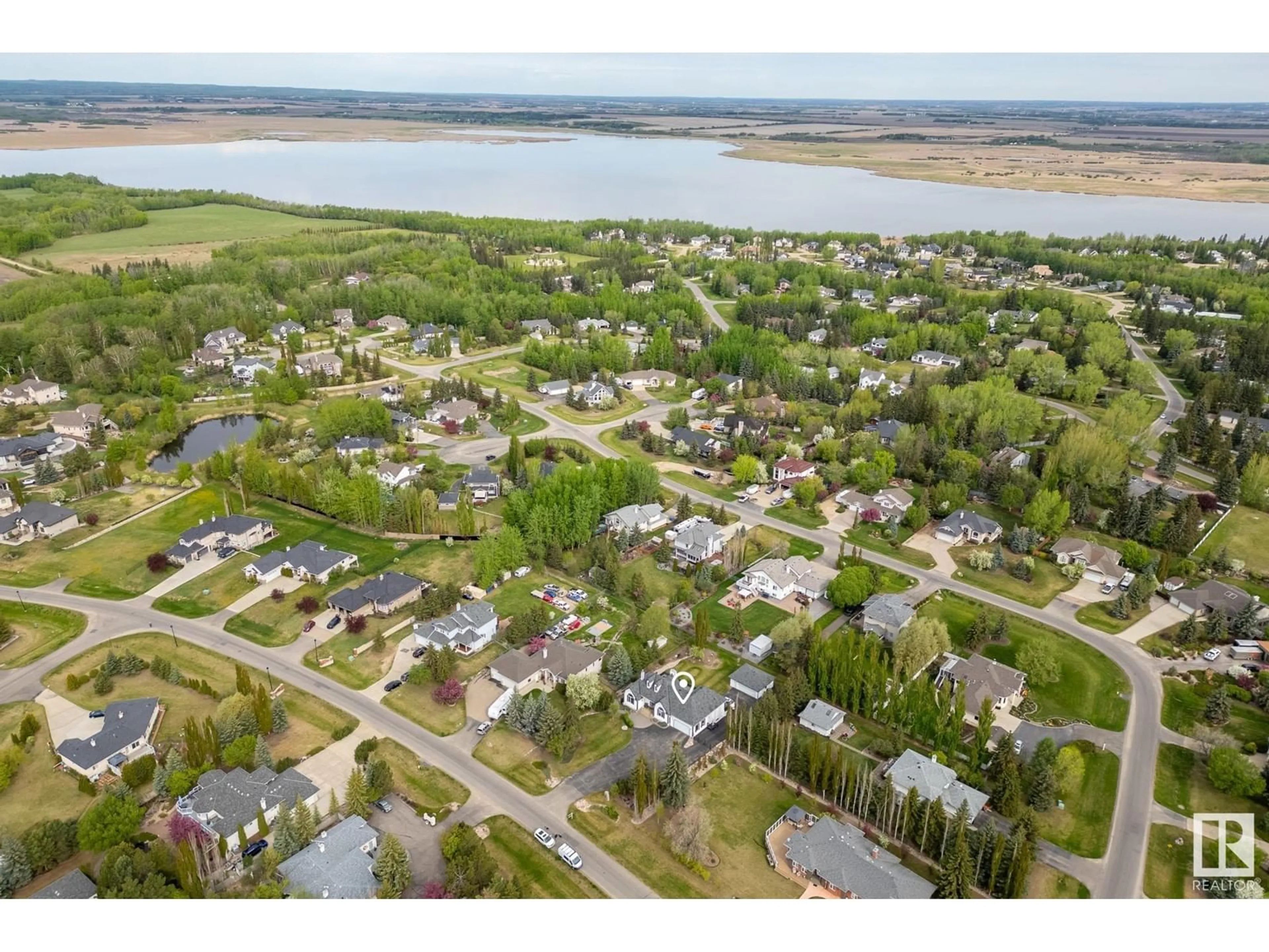 A pic from outside/outdoor area/front of a property/back of a property/a pic from drone, water/lake/river/ocean view for 26106 TWP ROAD 532 A, Rural Parkland County Alberta T7Y1A3