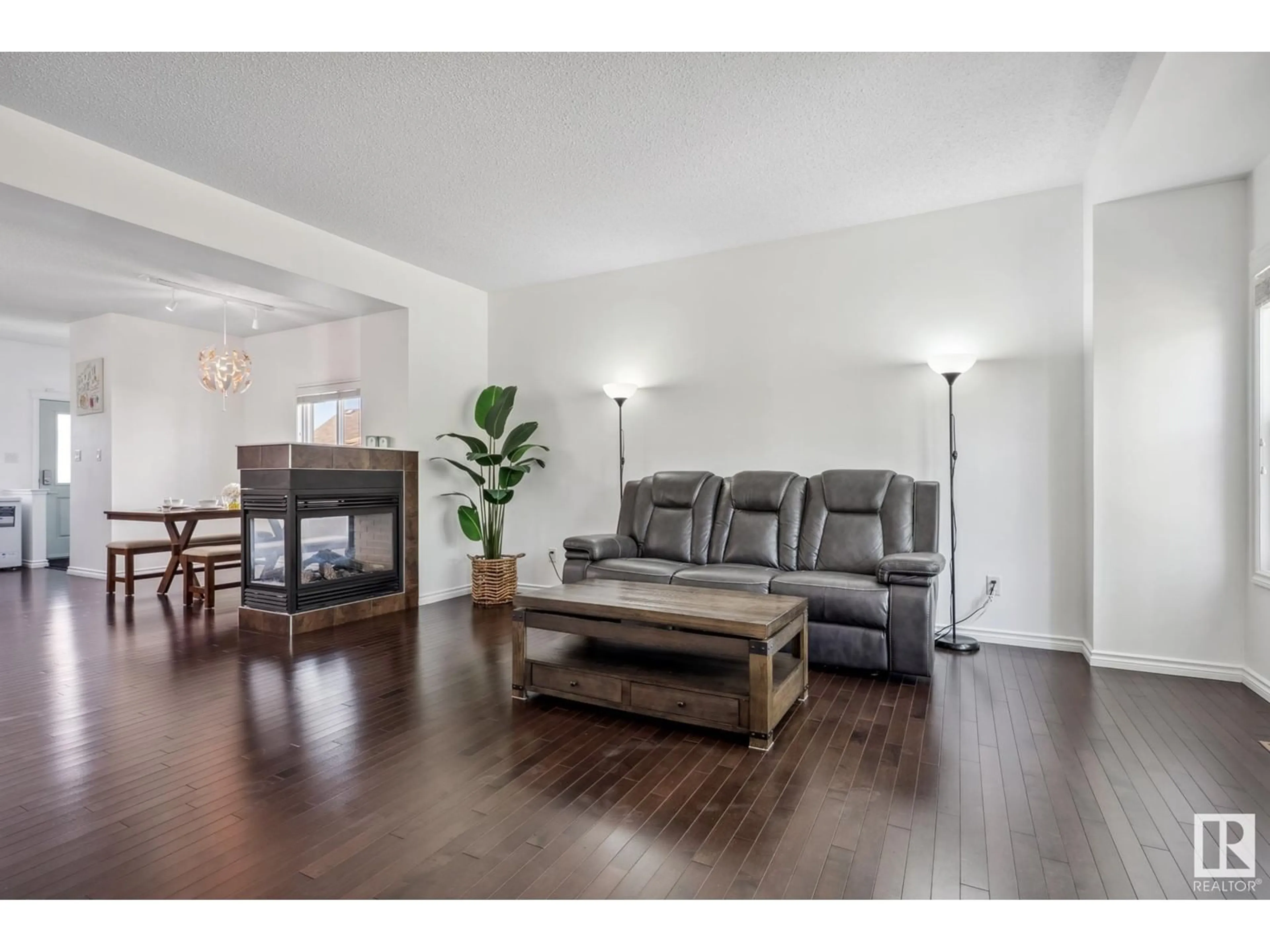Living room with furniture, wood/laminate floor for SW - 1624 57 ST, Edmonton Alberta T6X1P9