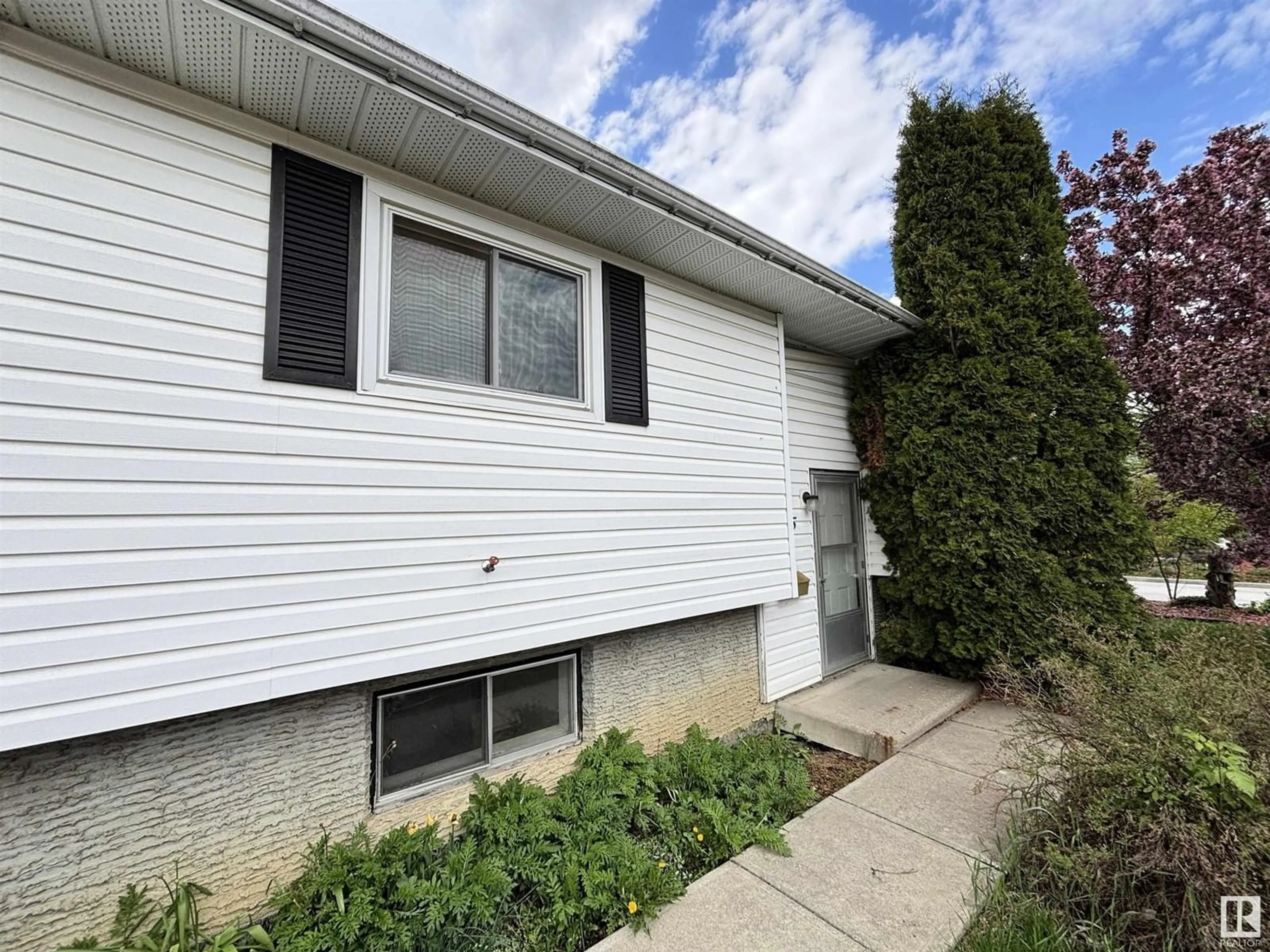 Home with vinyl exterior material, street for 7115 12 AV, Edmonton Alberta T6K3H6