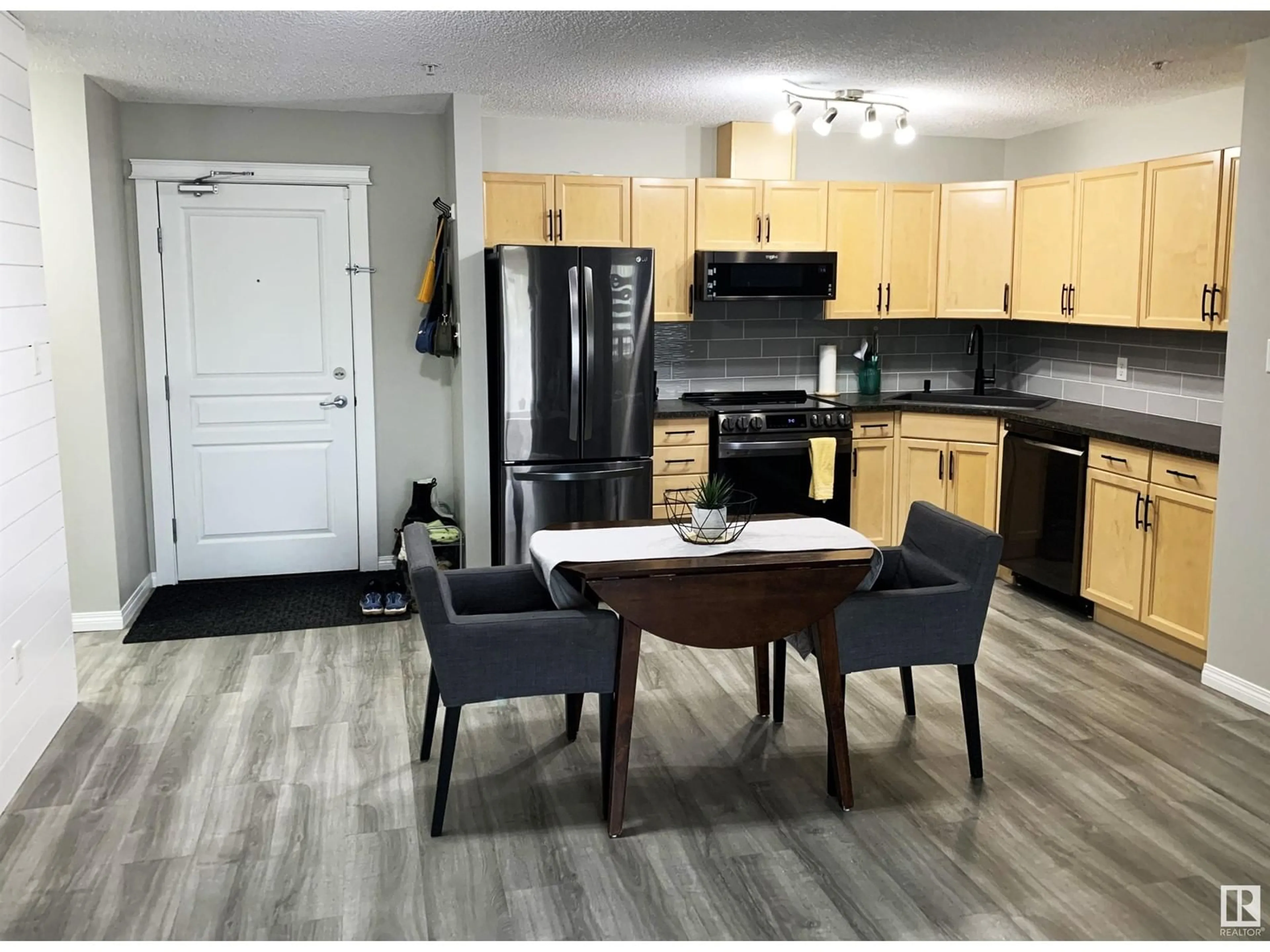 Open concept kitchen, wood/laminate floor for 309 - 118 CLAREVIEW STATION DR, Edmonton Alberta T5Y0C5