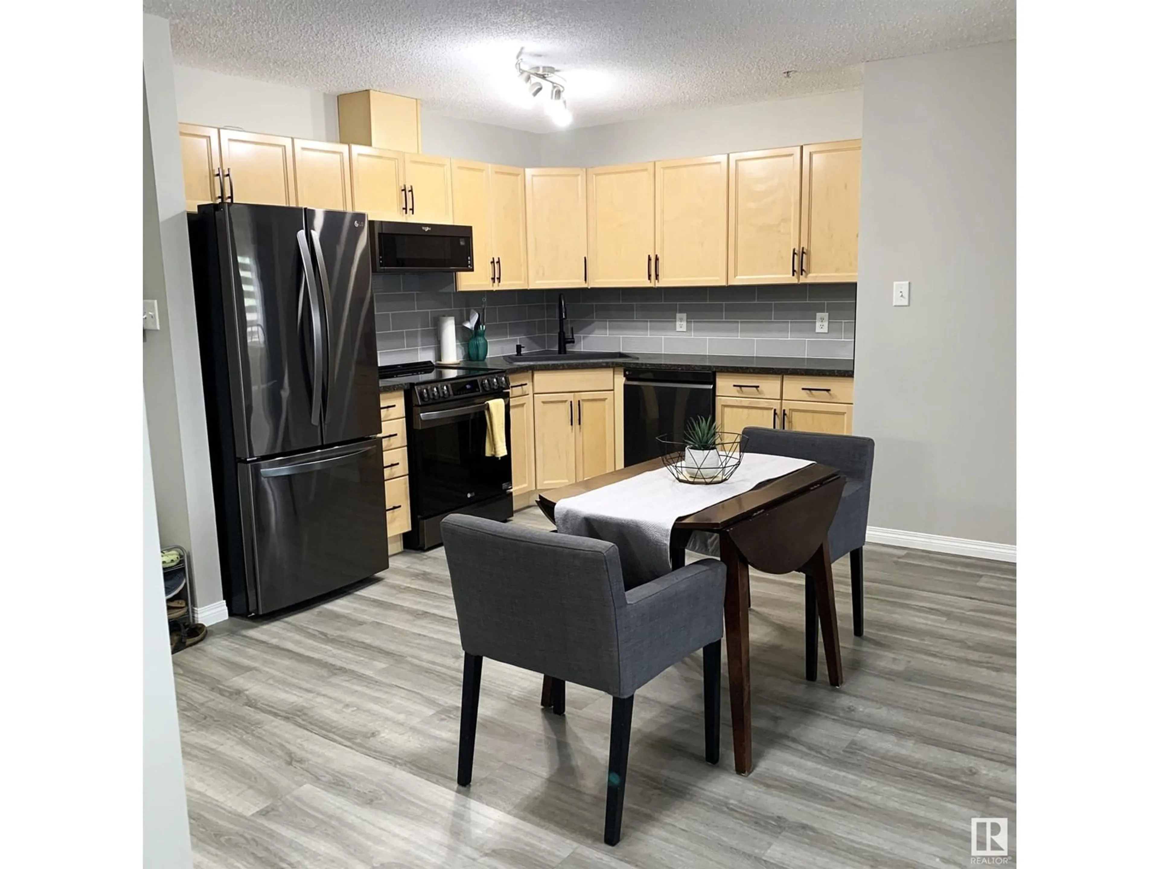 Open concept kitchen, wood/laminate floor for 309 - 118 CLAREVIEW STATION DR, Edmonton Alberta T5Y0C5