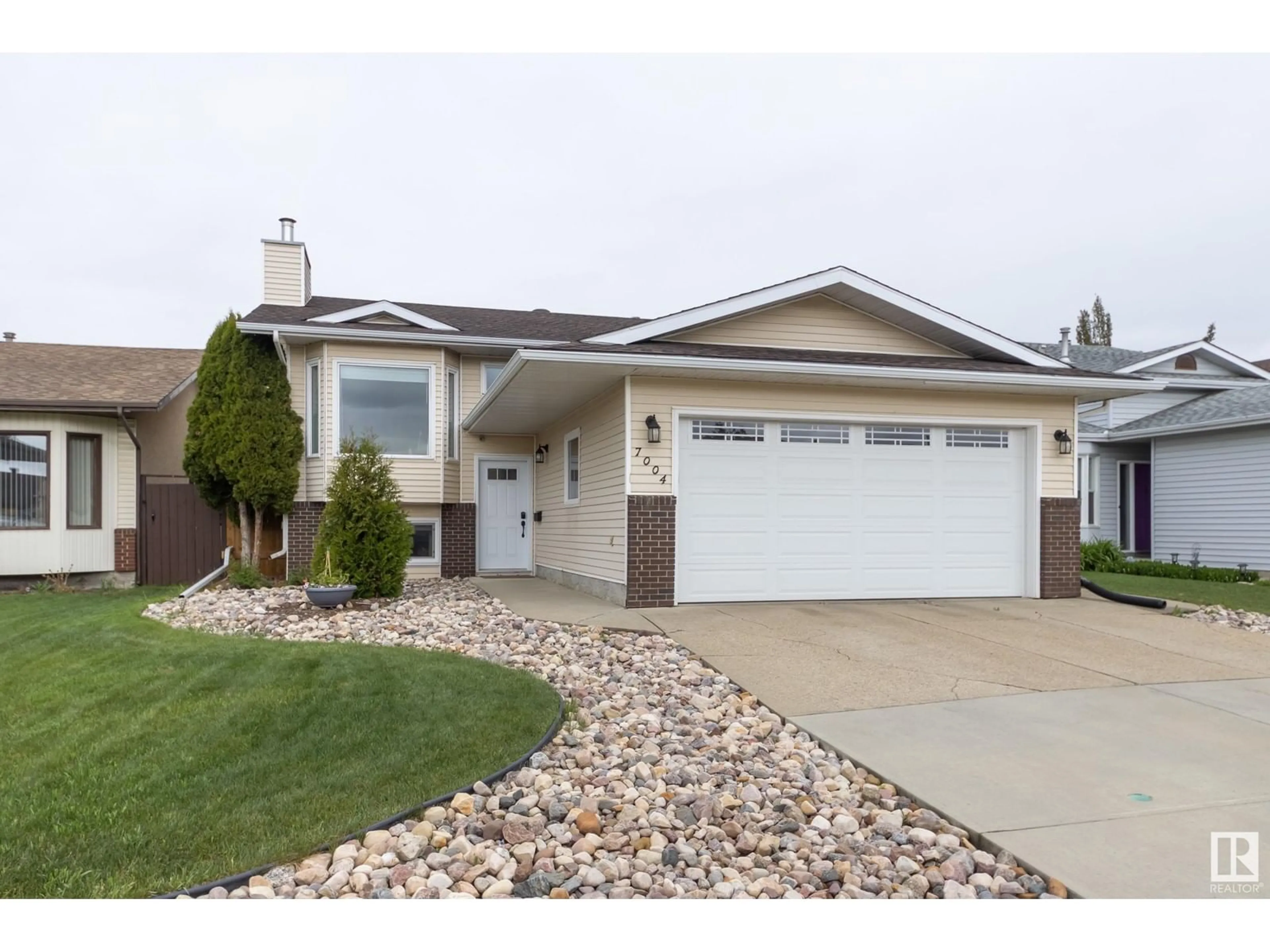Home with vinyl exterior material, street for NW - 7004 152C AV, Edmonton Alberta T5C3P4