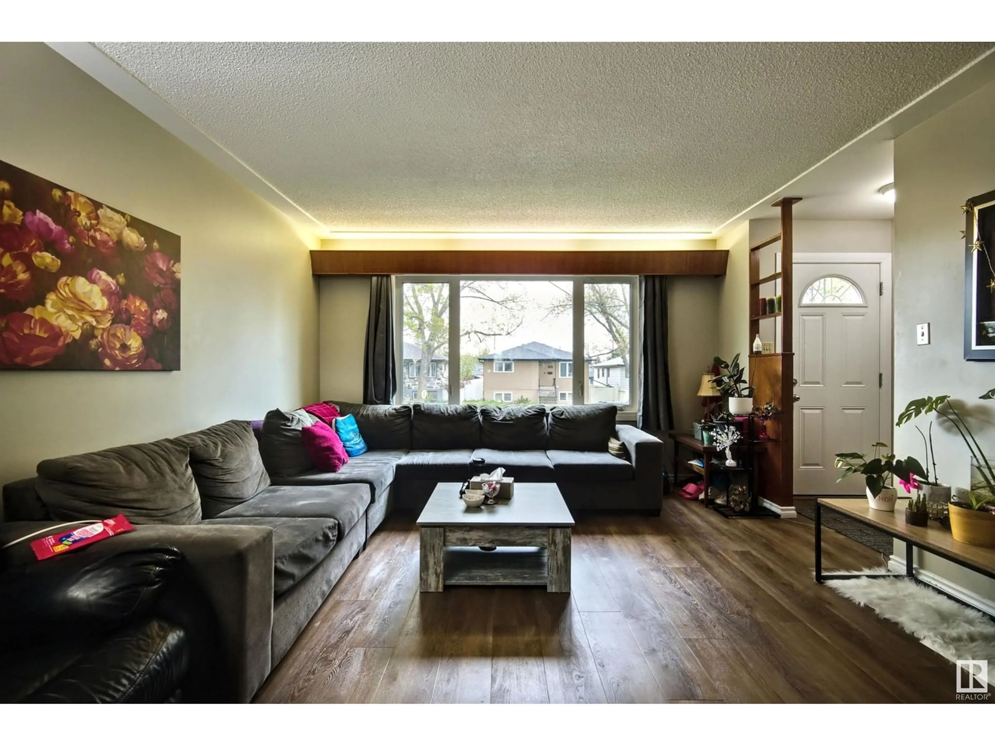 Living room with furniture, wood/laminate floor for NW - 13008-130010 102 ST, Edmonton Alberta T6H4B2