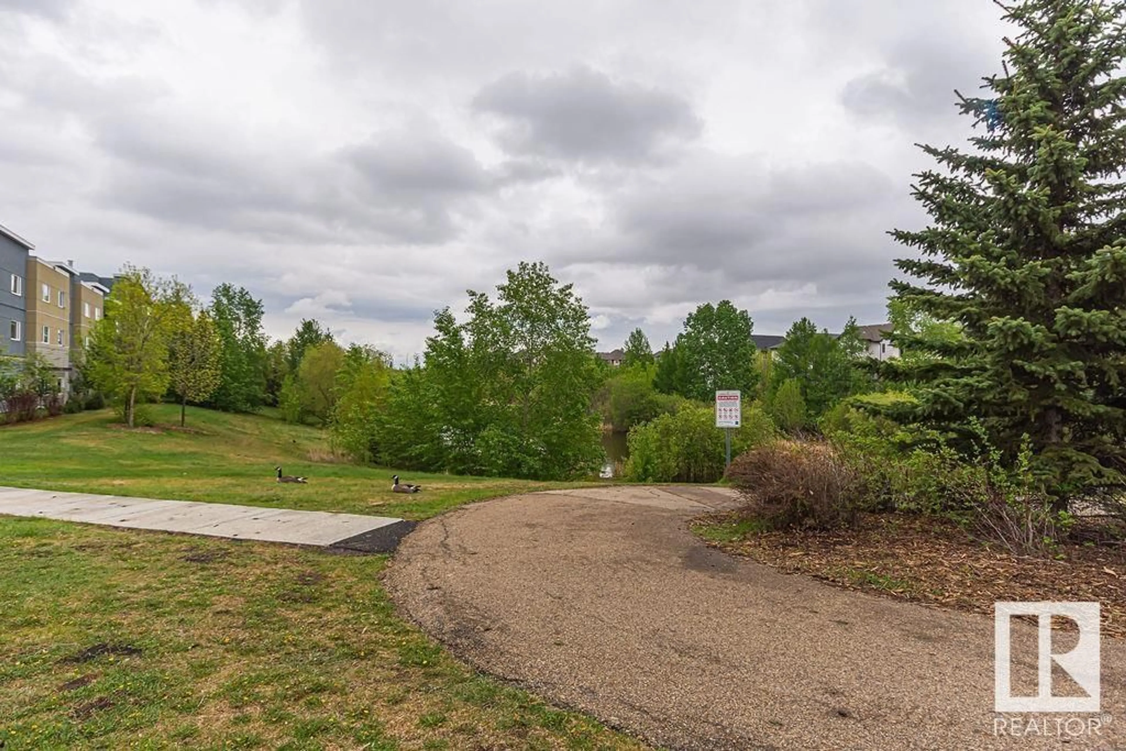 A pic from outside/outdoor area/front of a property/back of a property/a pic from drone, forest/trees view for 11453 - 311 ELLERSLIE RD SW, Edmonton Alberta T6W1T3