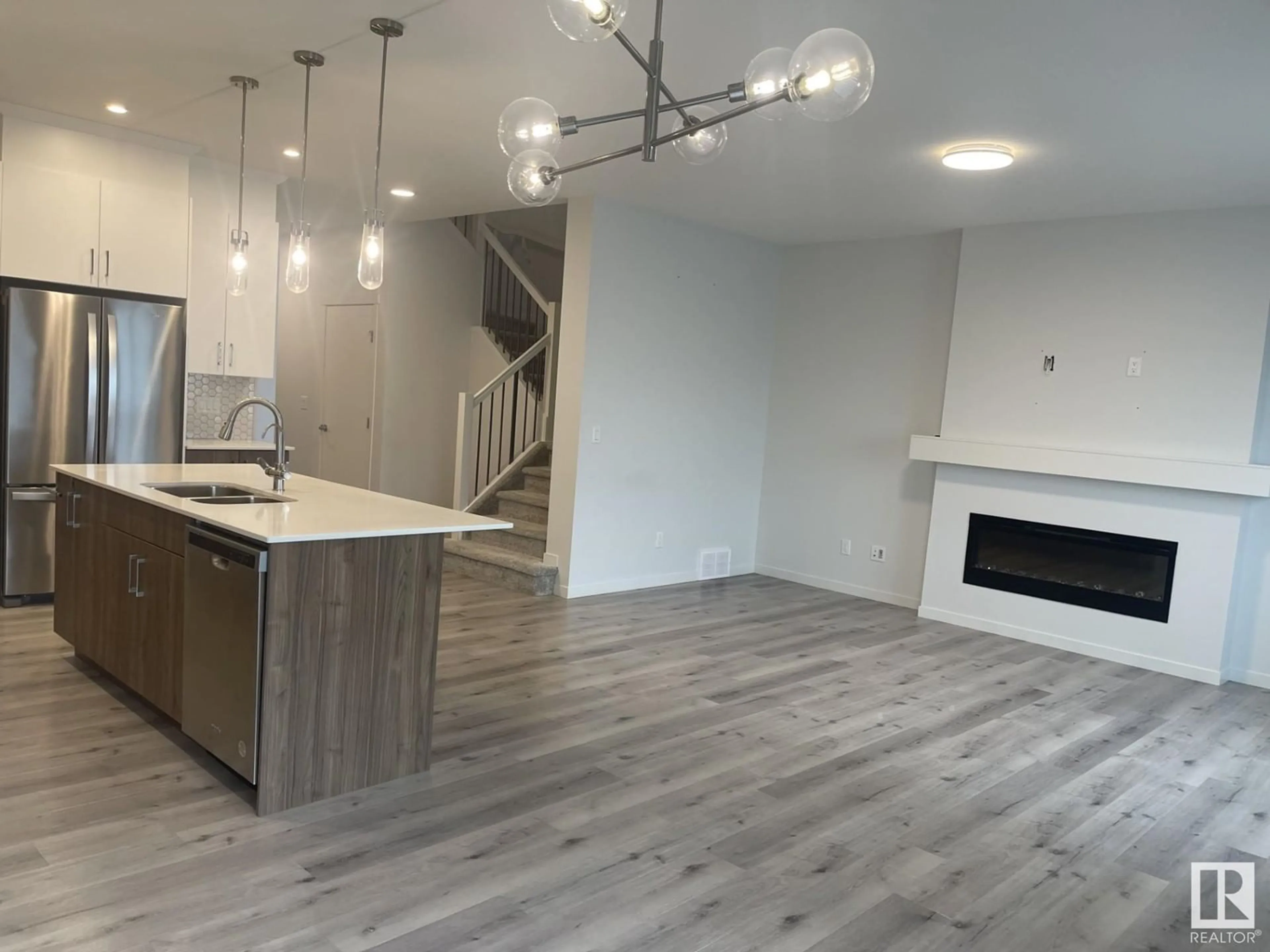 Open concept kitchen, wood/laminate floor for NW - 2627 200 ST, Edmonton Alberta T6M1K3