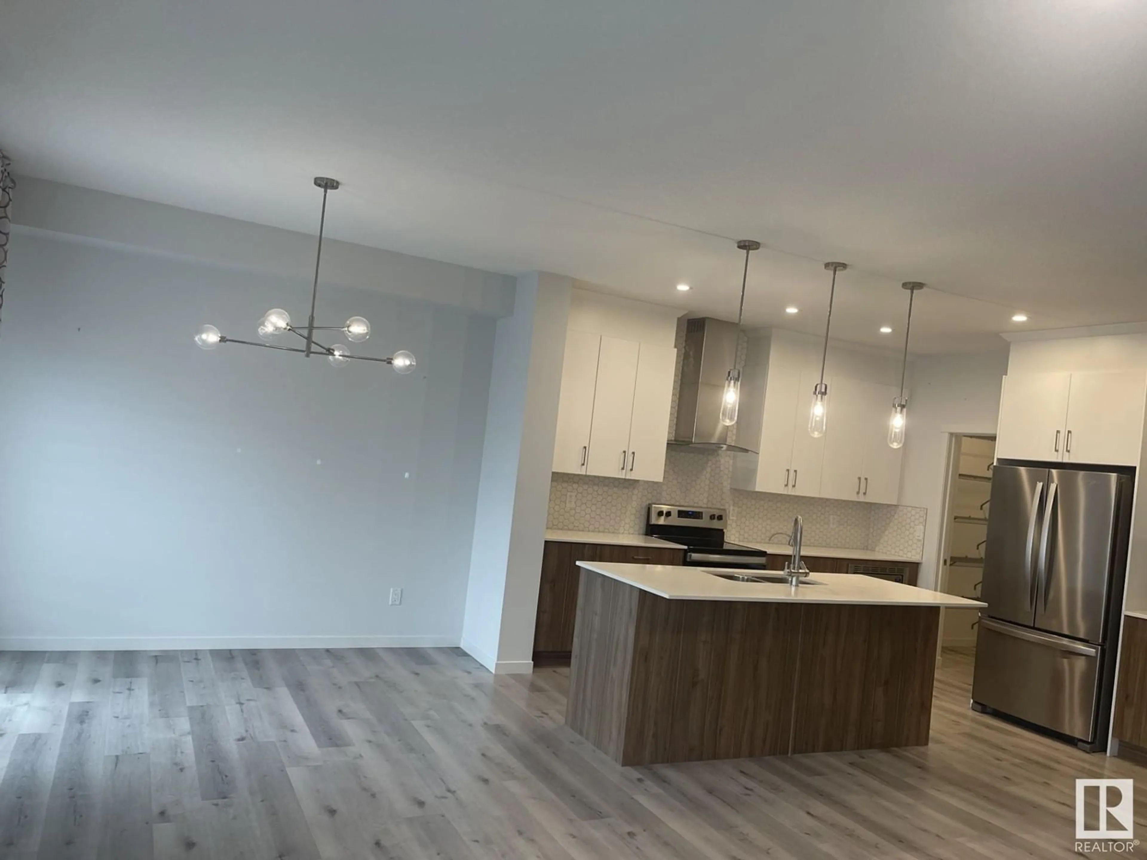 Open concept kitchen, wood/laminate floor for NW - 2627 200 ST, Edmonton Alberta T6M1K3