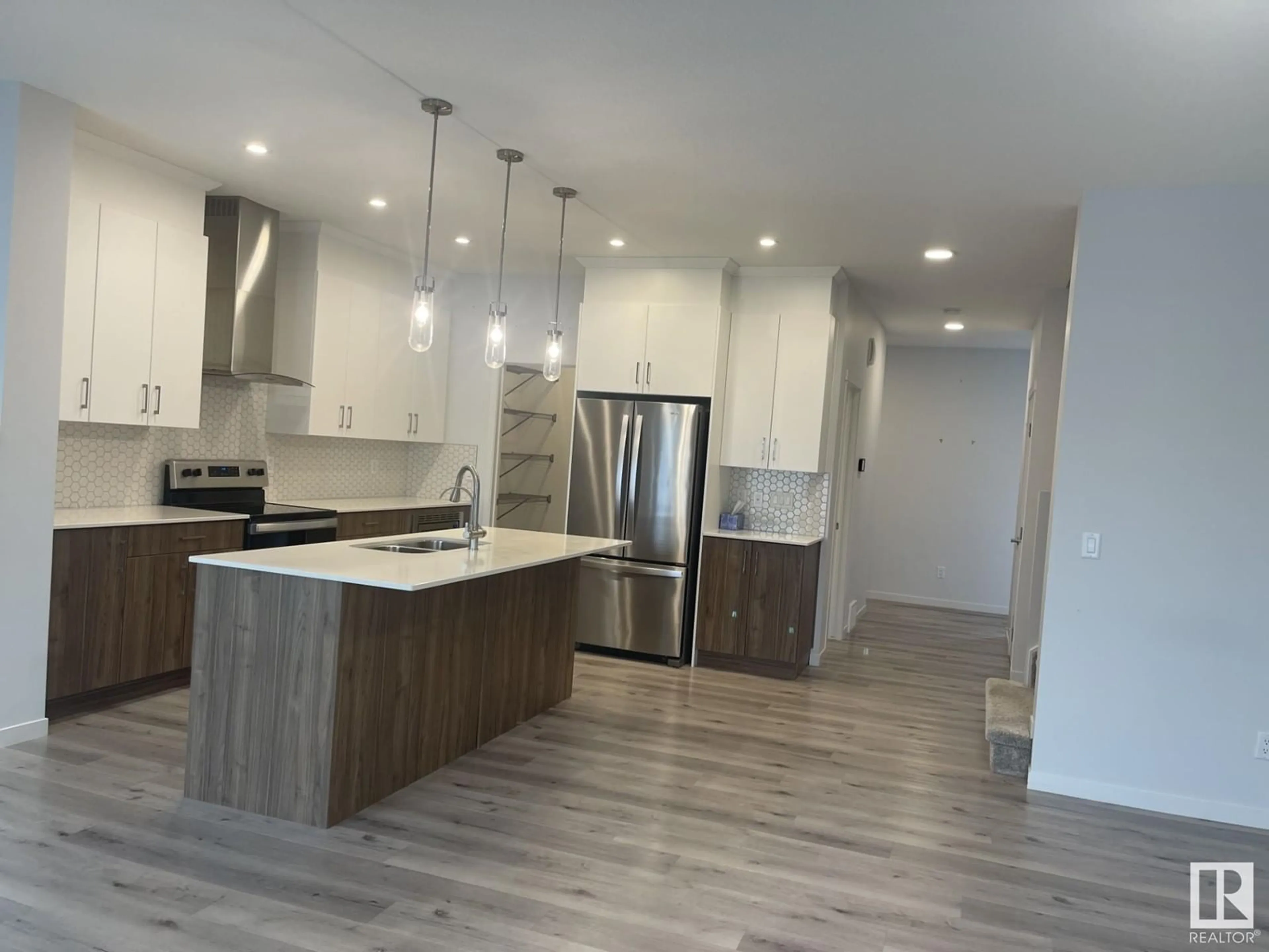 Open concept kitchen, wood/laminate floor for NW - 2627 200 ST, Edmonton Alberta T6M1K3