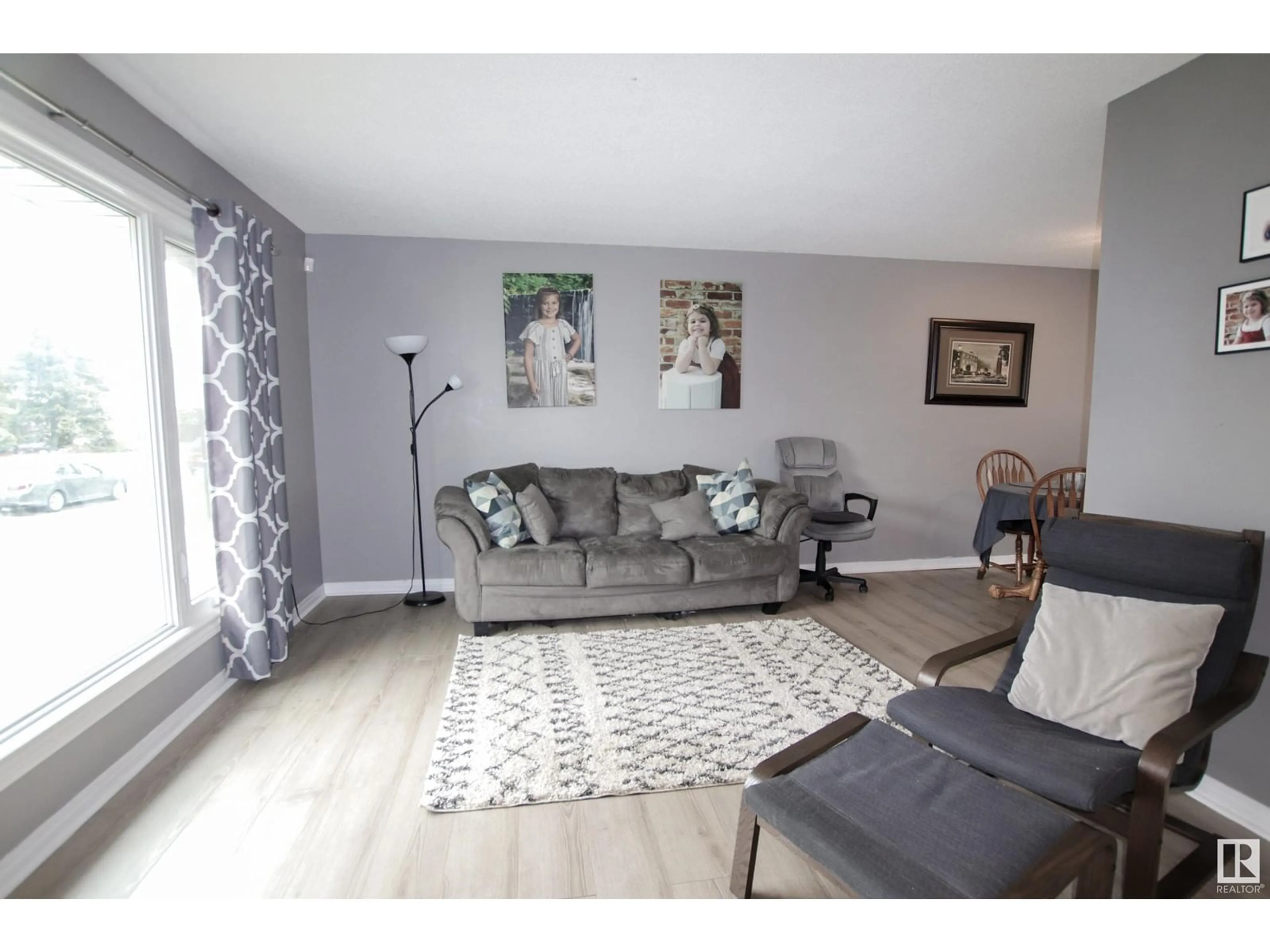 Living room with furniture, wood/laminate floor for 6121 34A AV, Edmonton Alberta T6L1C9