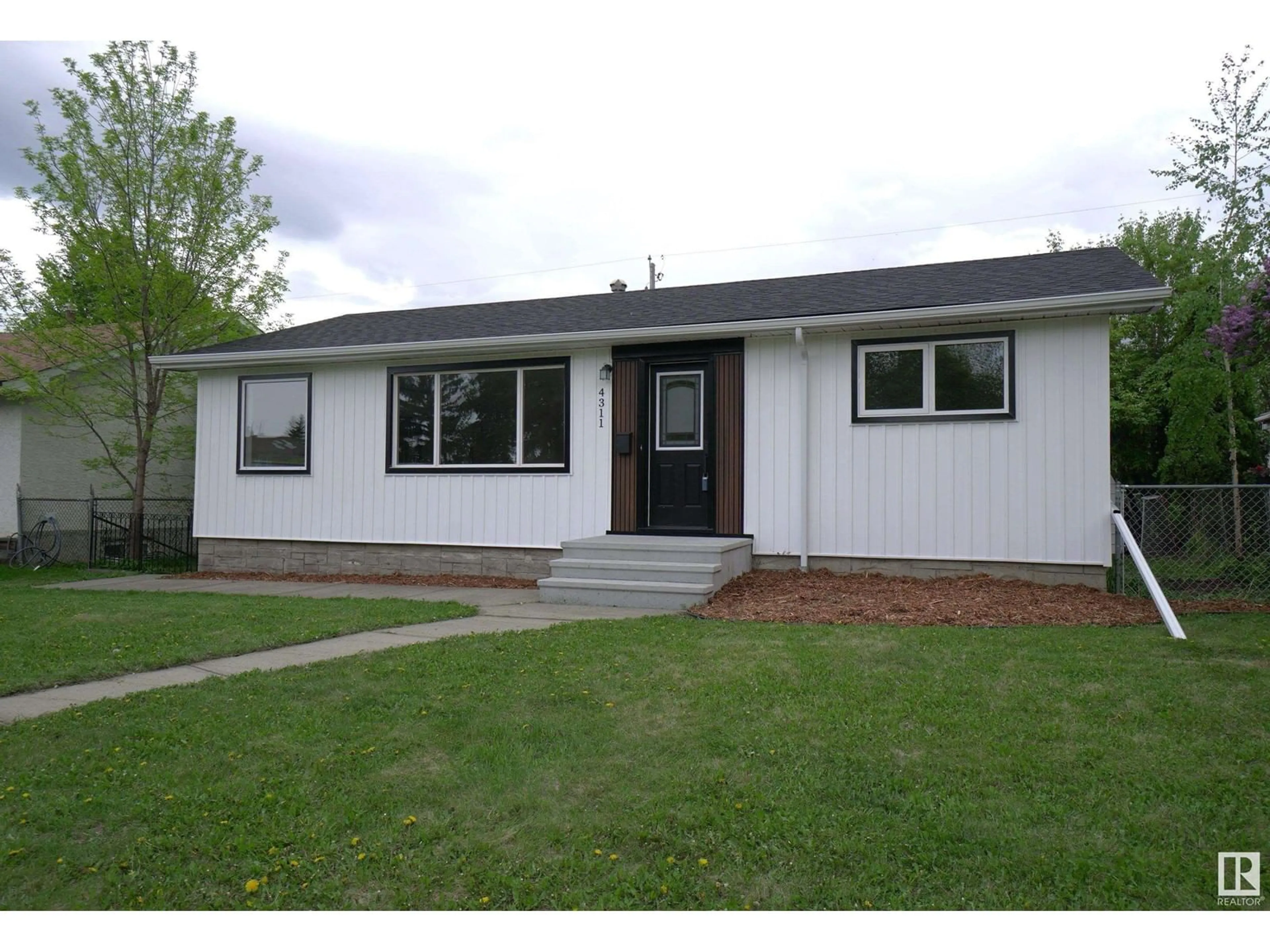 Home with vinyl exterior material, street for 4311 106 AV, Edmonton Alberta T6A1E1