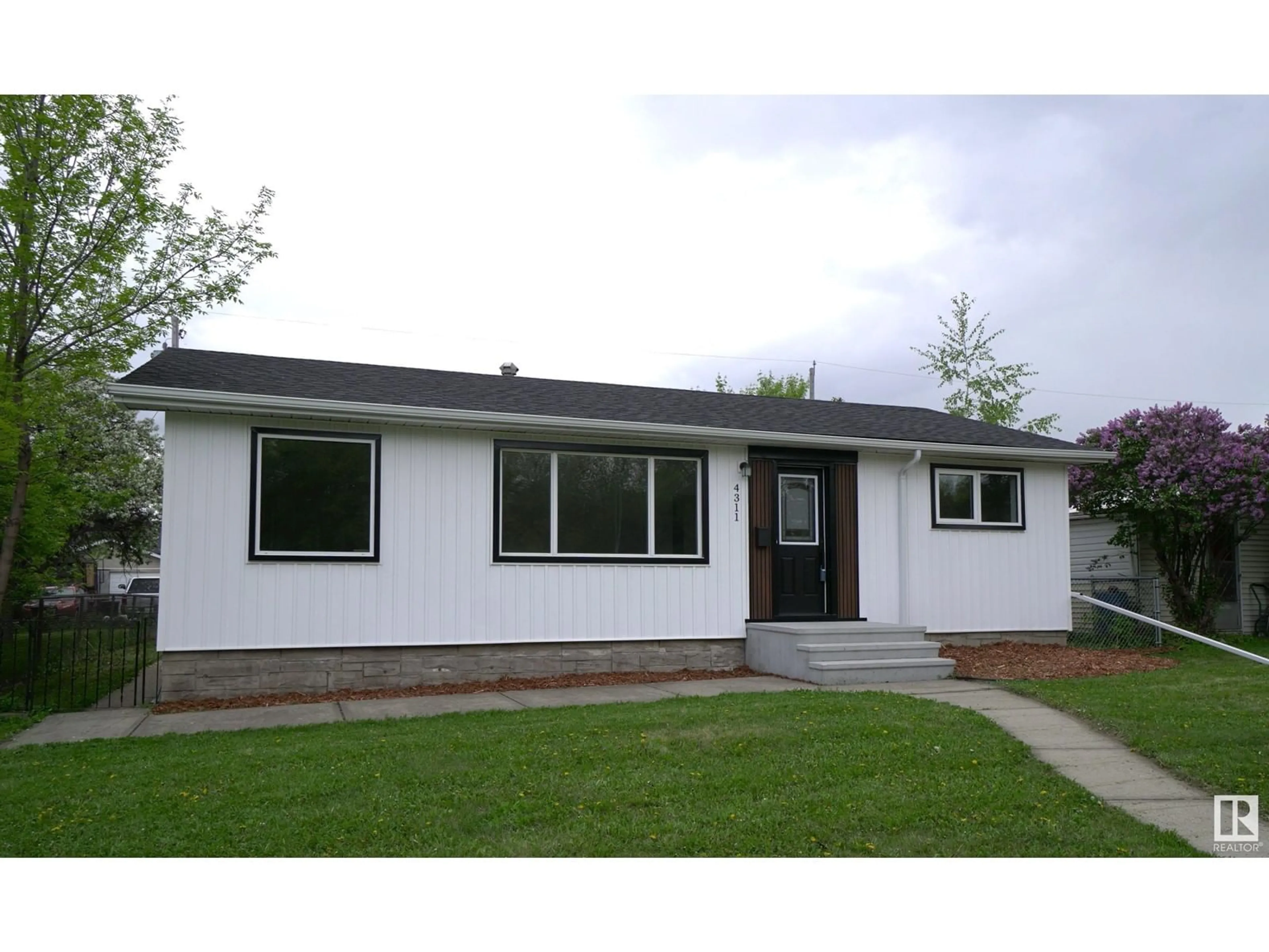 Home with vinyl exterior material, street for 4311 106 AV, Edmonton Alberta T6A1E1