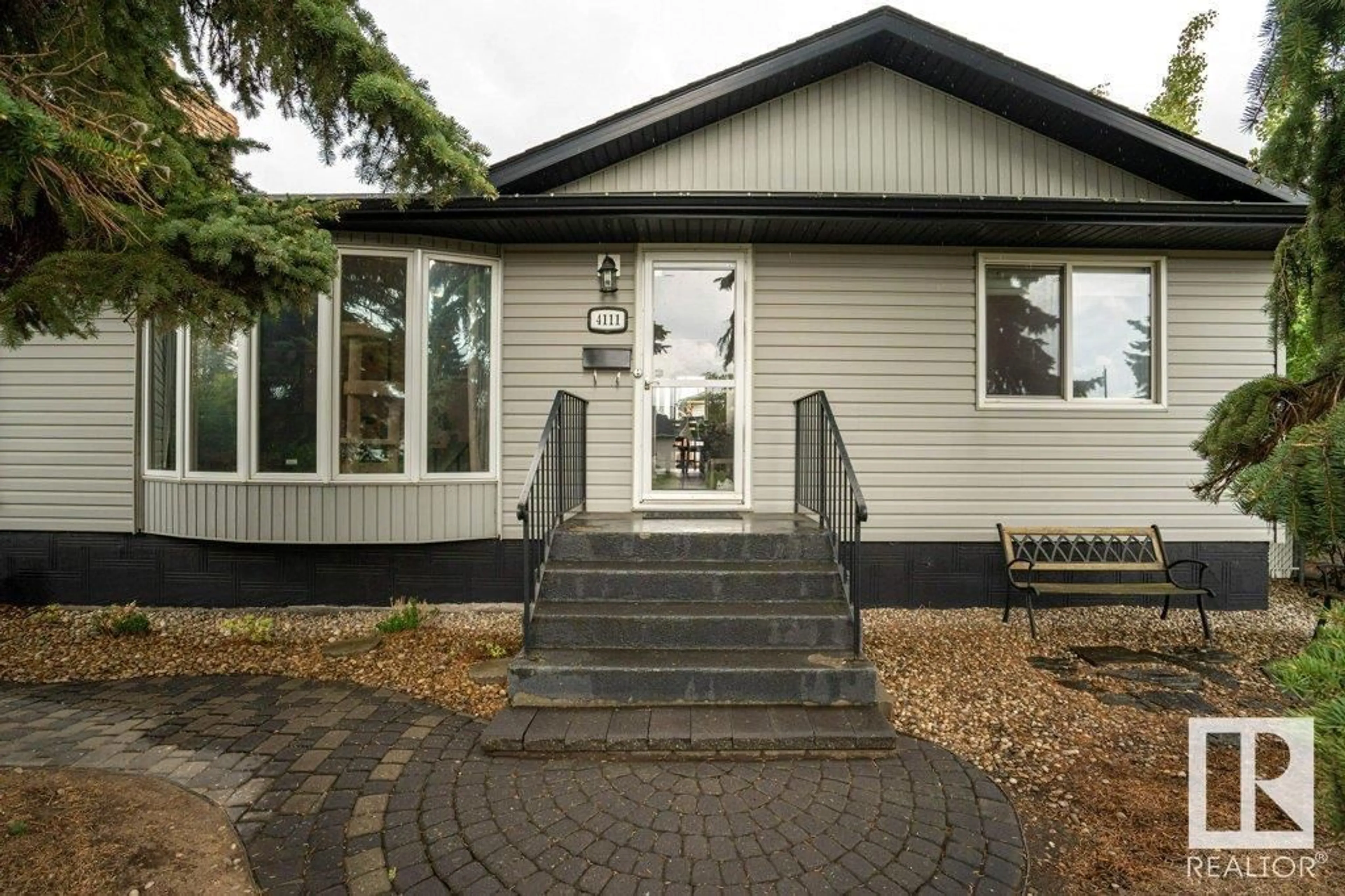 Home with vinyl exterior material, street for 4111 105 AV, Edmonton Alberta T6A1A1