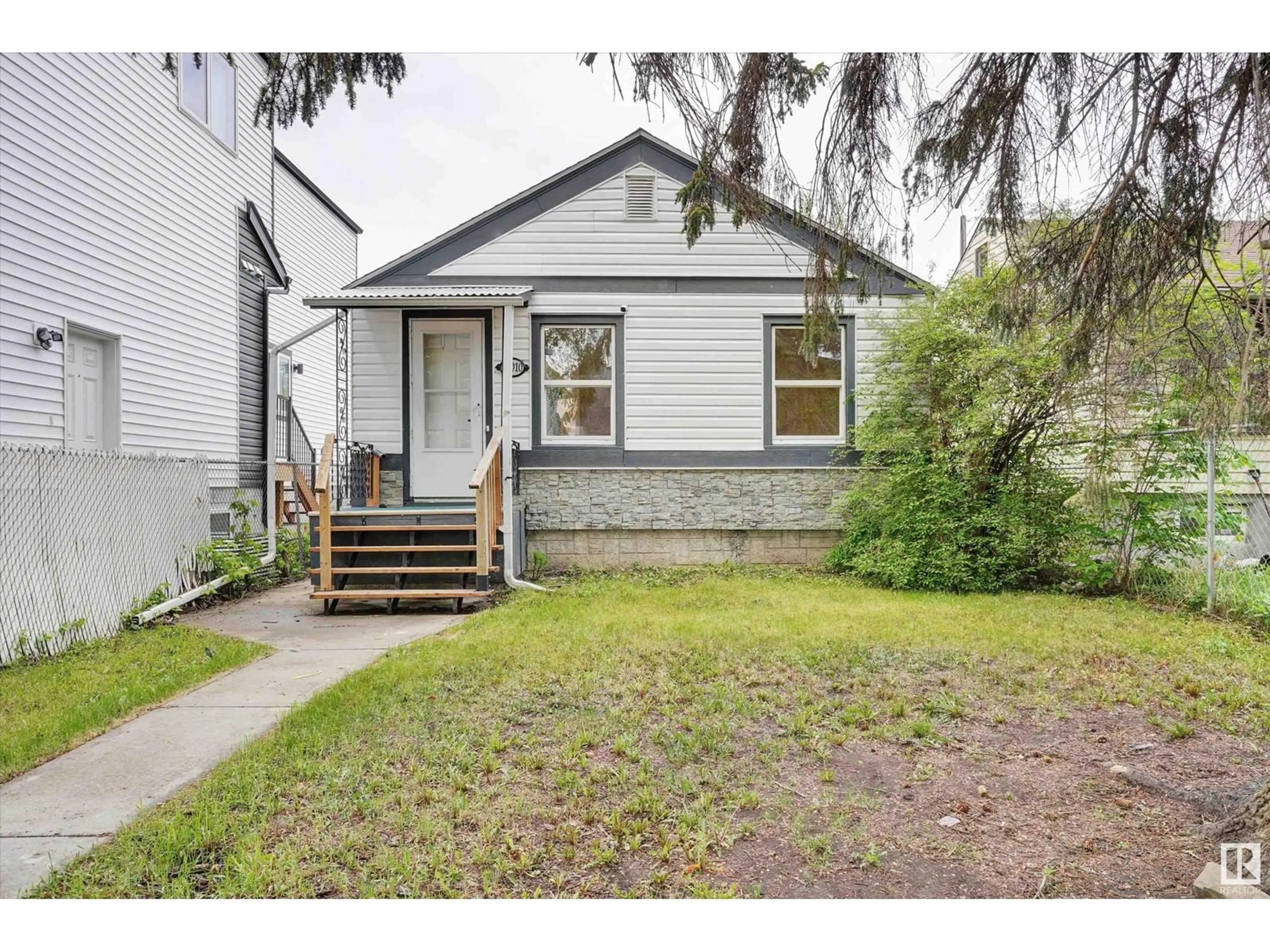 Home with vinyl exterior material, street for NW - 12010 91 ST, Edmonton Alberta T5B4B8