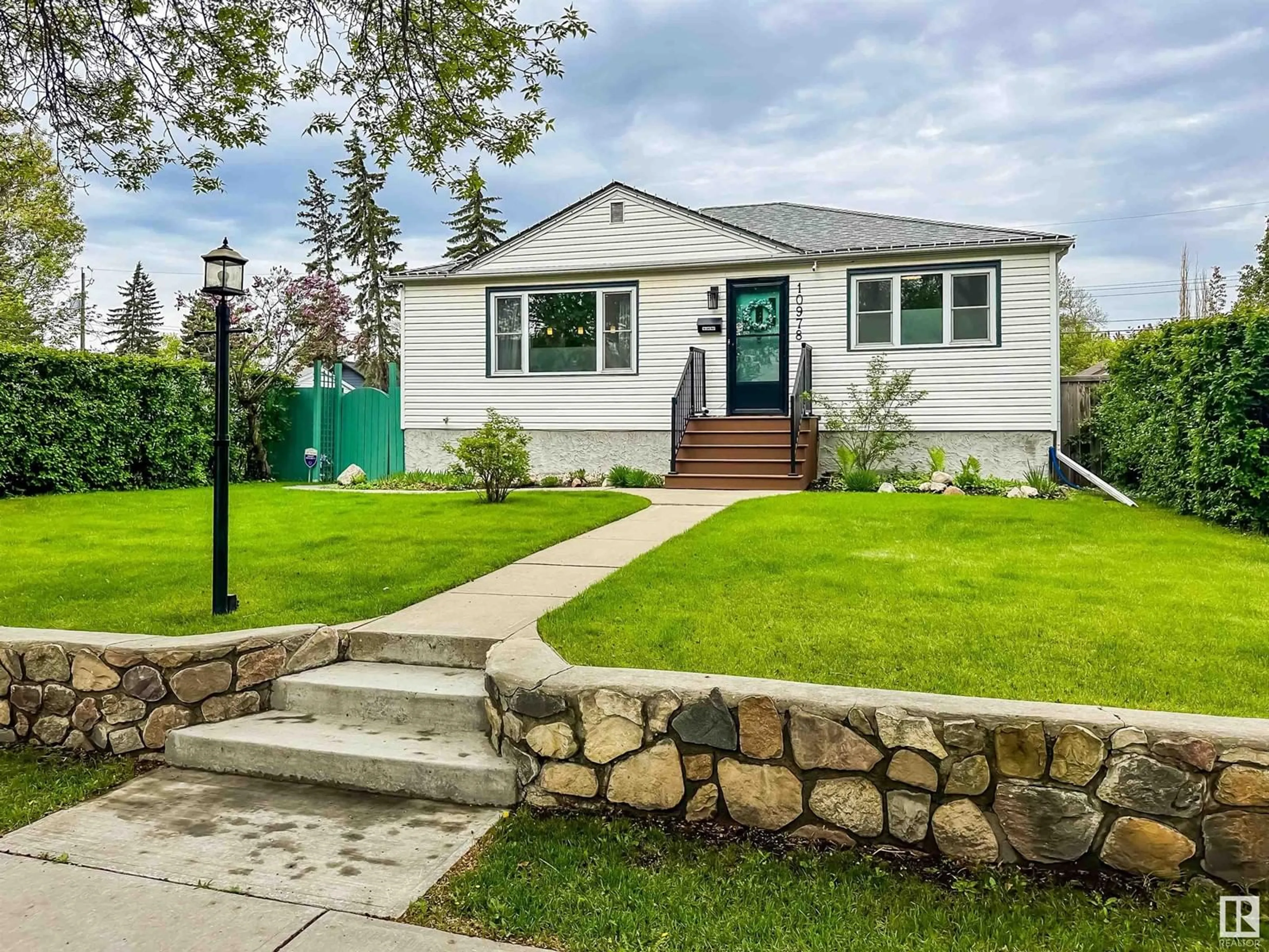 Home with vinyl exterior material, street for NW - 10978 135 ST, Edmonton Alberta T5M1K2