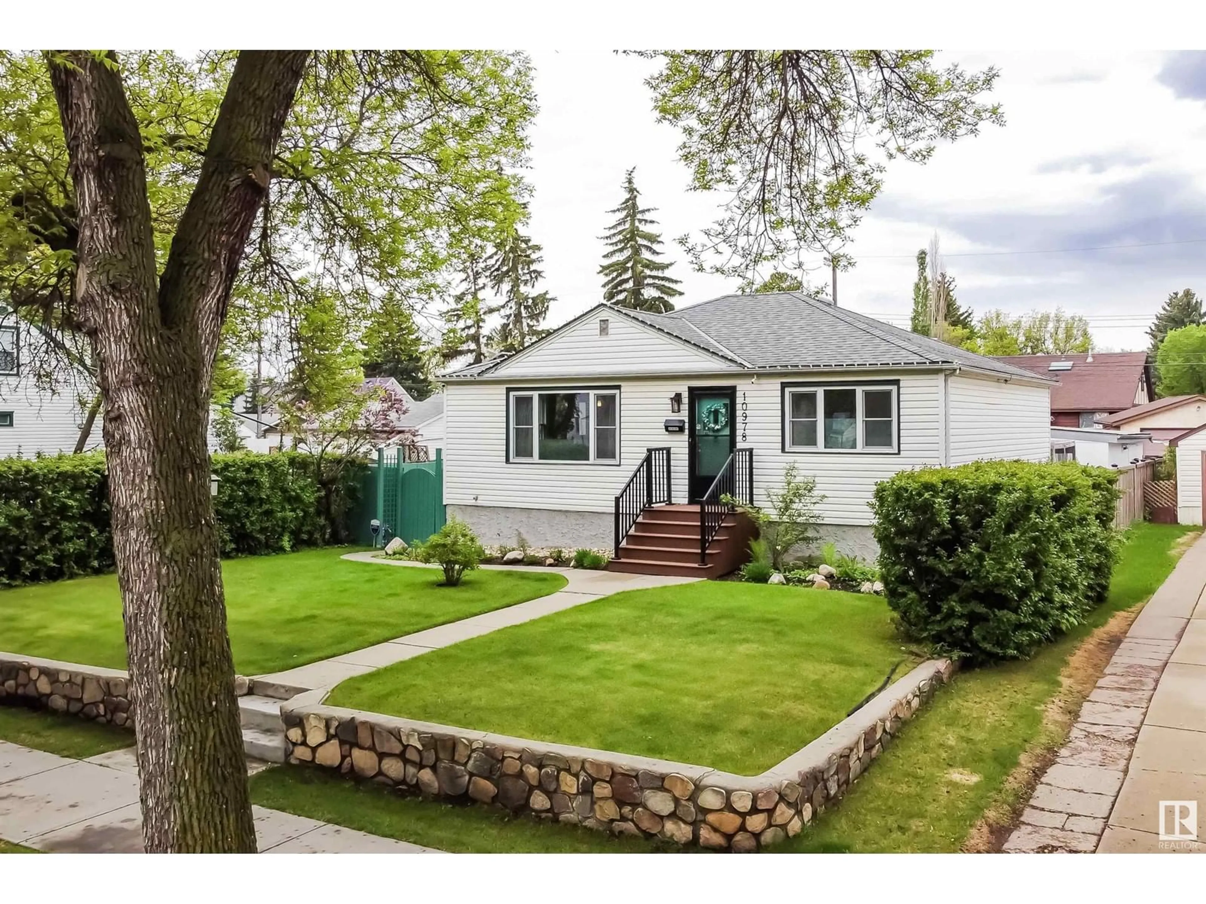 Home with vinyl exterior material, street for NW - 10978 135 ST, Edmonton Alberta T5M1K2