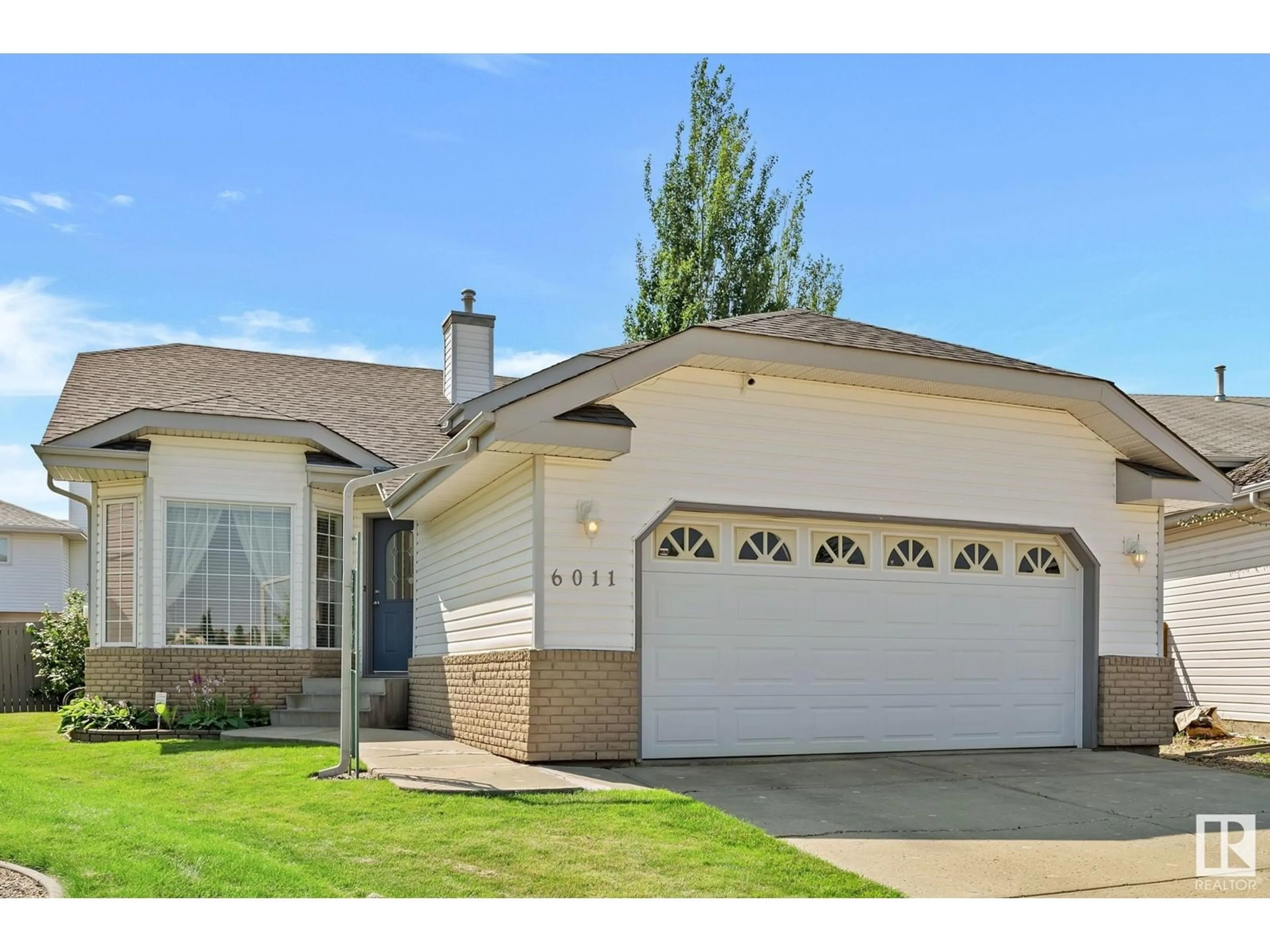 Home with vinyl exterior material, street for NW - 6011 159 AV, Edmonton Alberta T5Y2P4