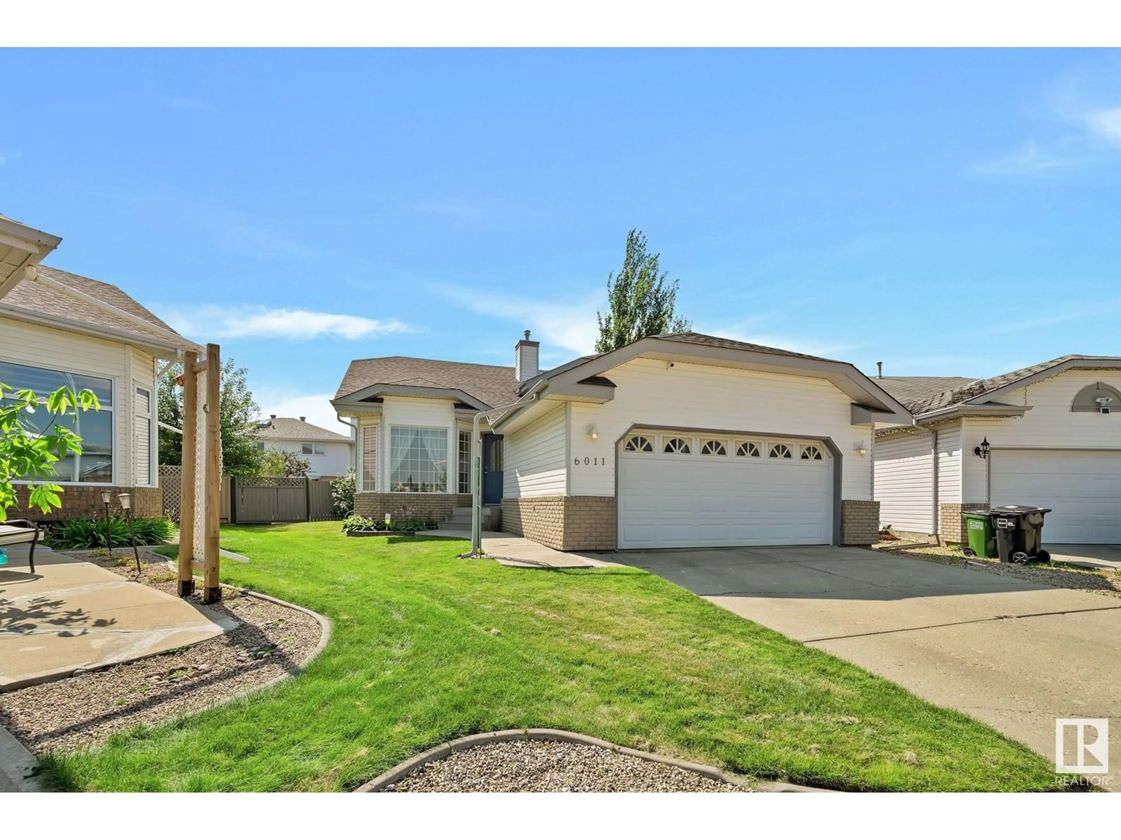 Home with vinyl exterior material, street for NW - 6011 159 AV, Edmonton Alberta T5Y2P4