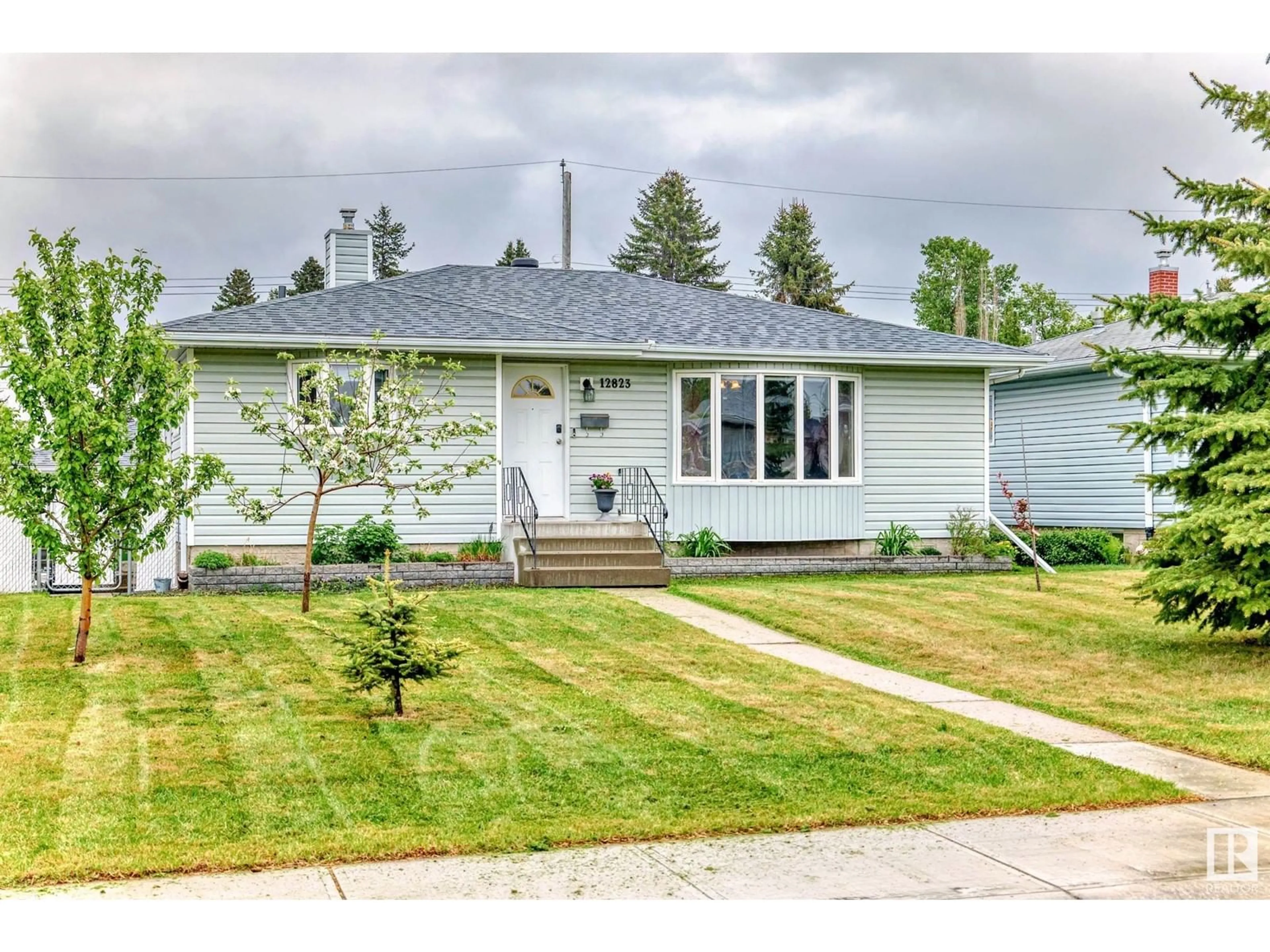Home with vinyl exterior material, street for 12823 95A ST, Edmonton Alberta T5E3Z8
