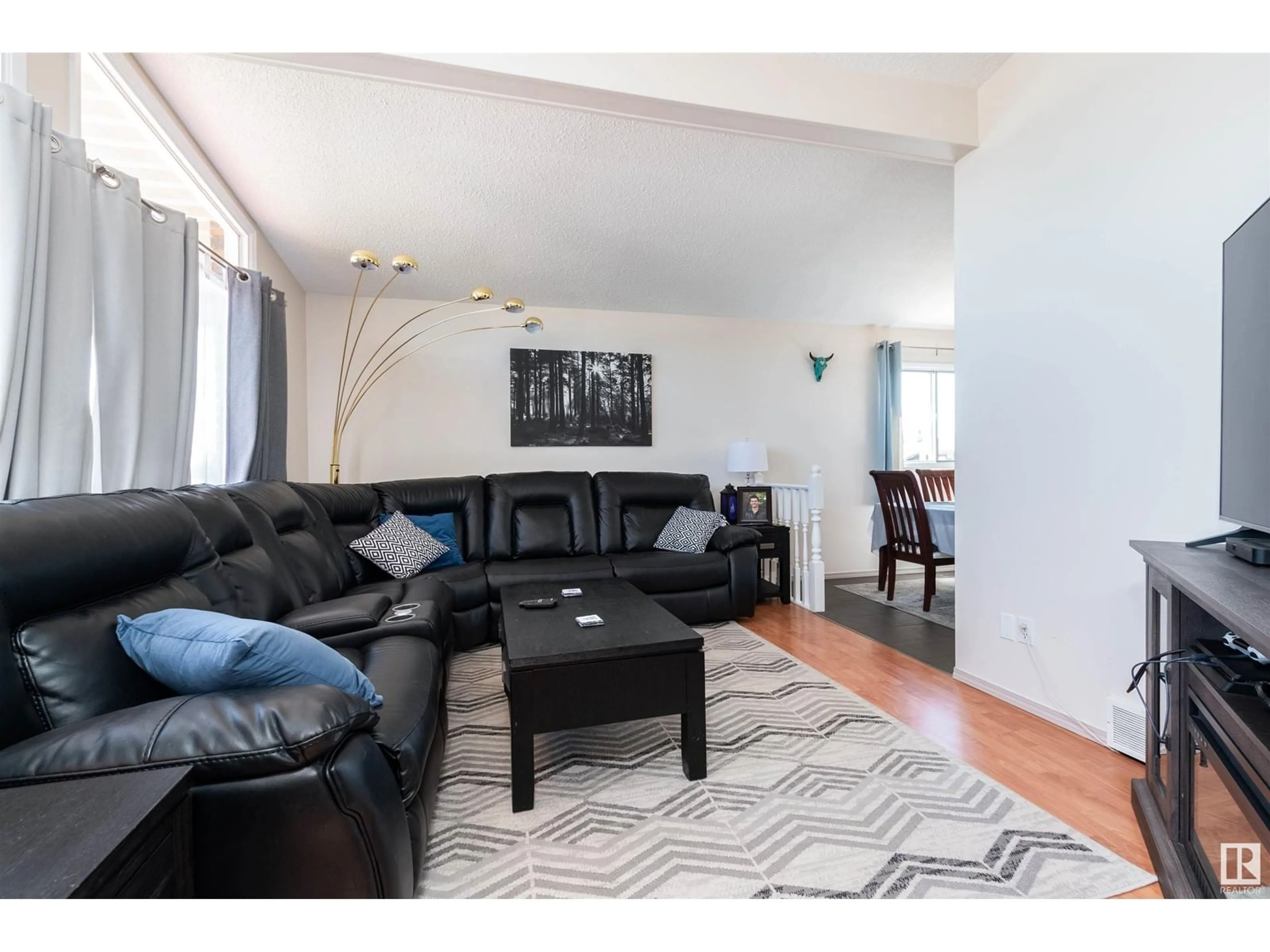 Living room with furniture, wood/laminate floor for NW - 15712 114 ST, Edmonton Alberta T5X2M1