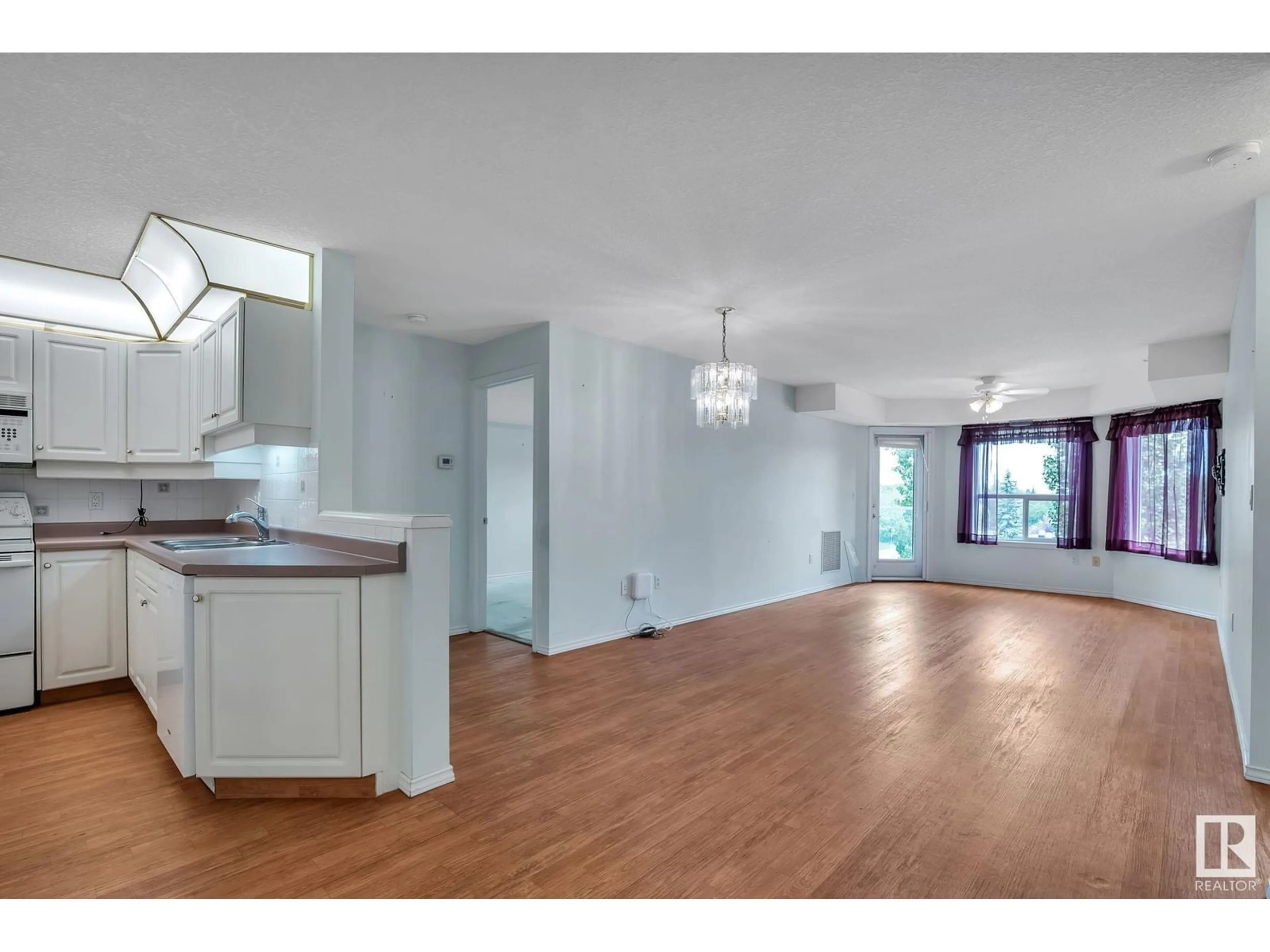 Open concept kitchen, wood/laminate floor for 407 - 6703 172 ST NW, Edmonton Alberta T5T6H9