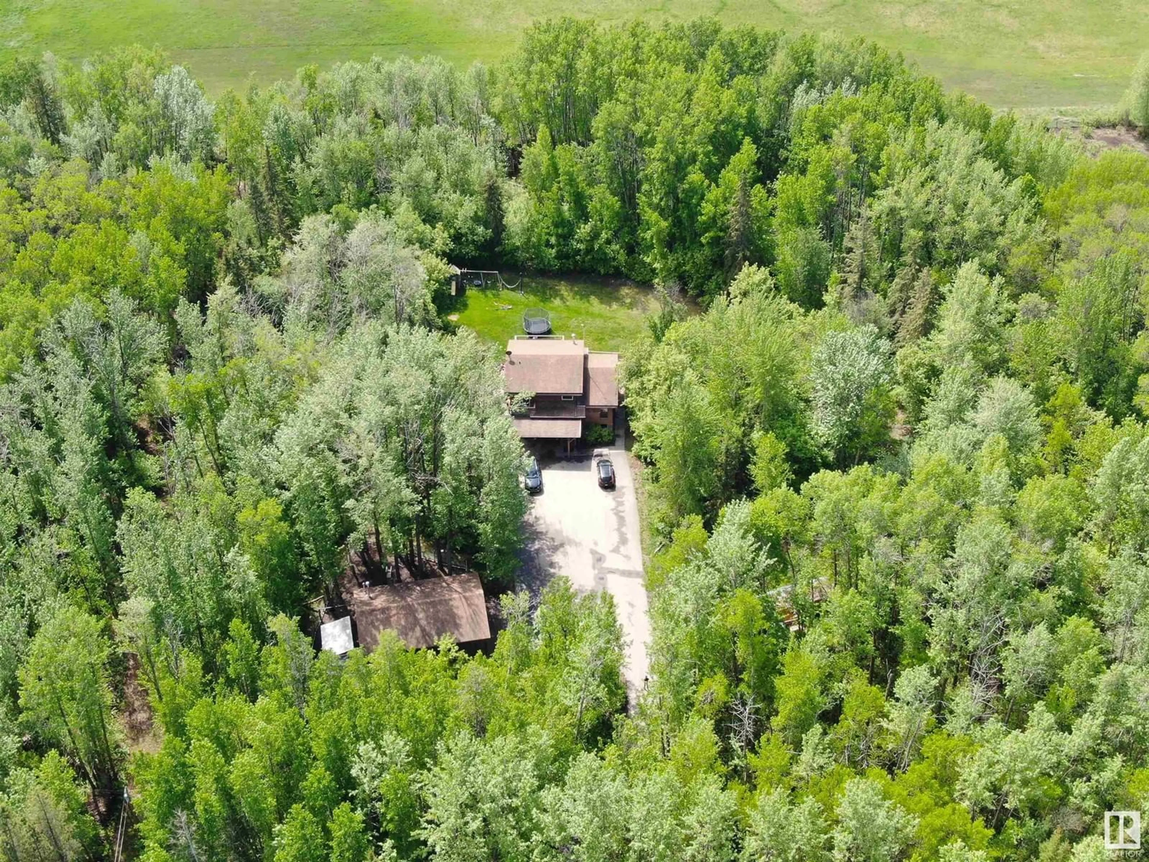 A pic from outside/outdoor area/front of a property/back of a property/a pic from drone, forest/trees view for 7 - 52215 RGE ROAD 270, Rural Parkland County Alberta T7X3L6