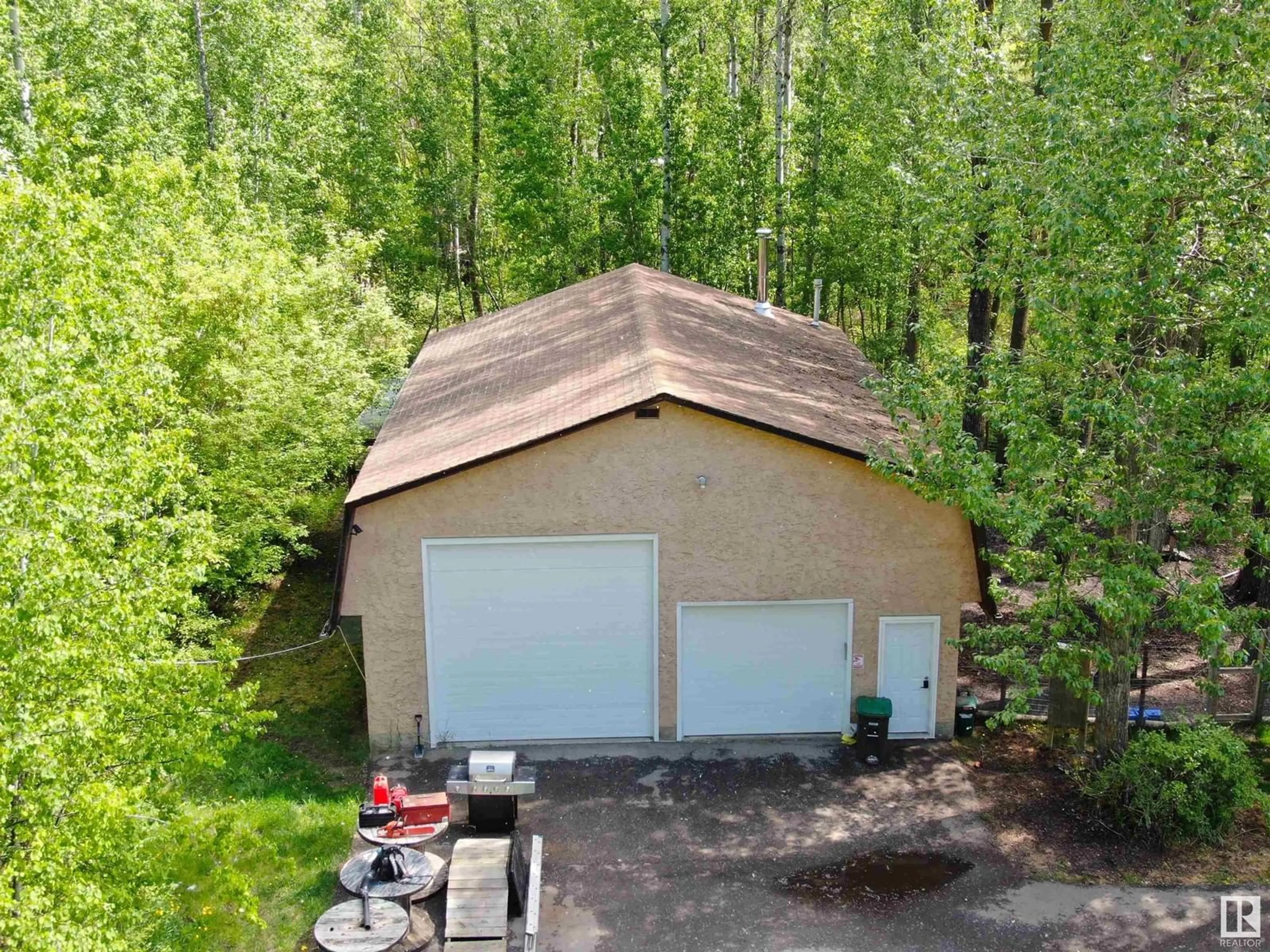 A pic from outside/outdoor area/front of a property/back of a property/a pic from drone, forest/trees view for 7 - 52215 RGE ROAD 270, Rural Parkland County Alberta T7X3L6