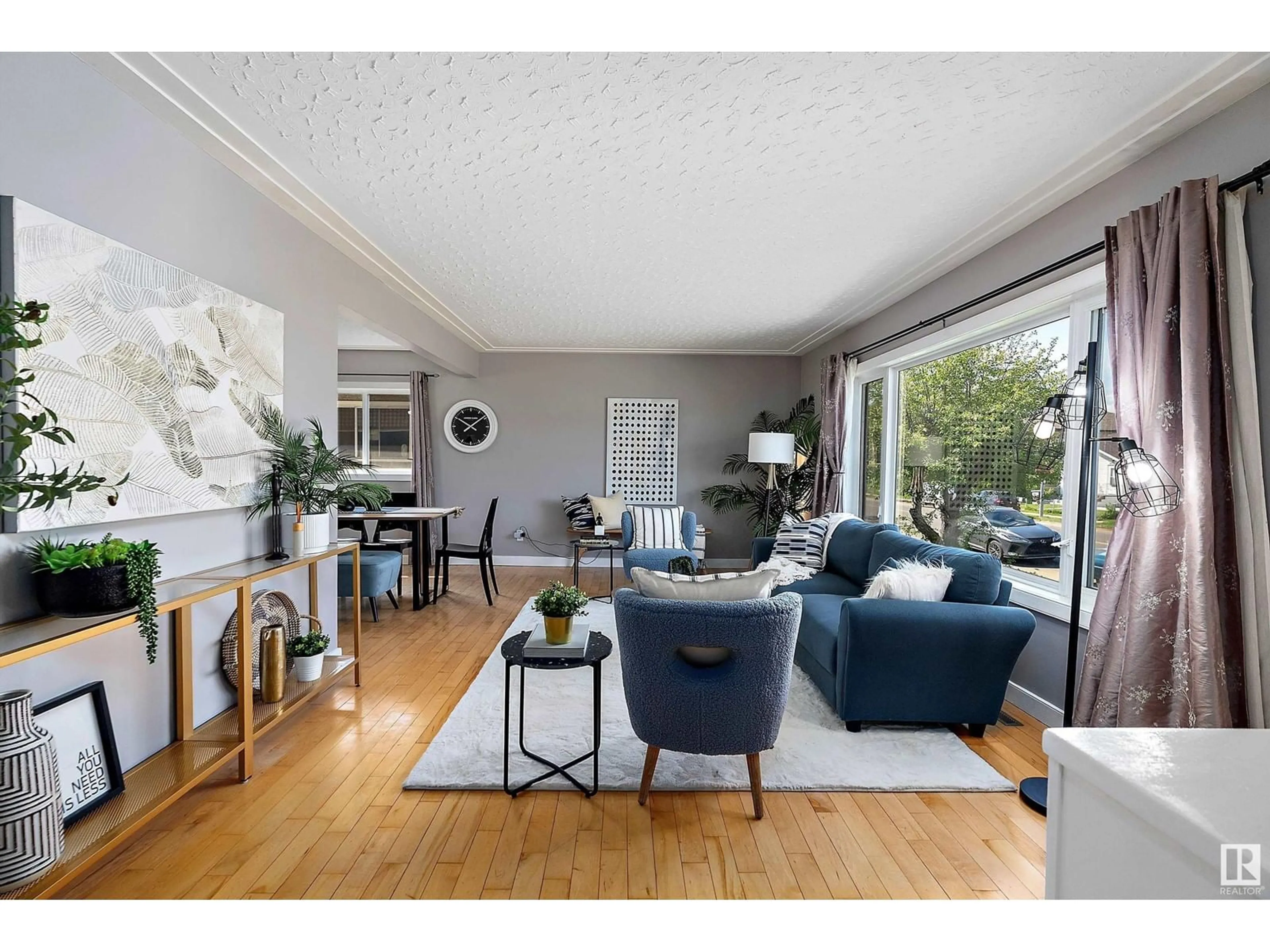 Living room with furniture, wood/laminate floor for NW - 10533 / 10535 79 ST, Edmonton Alberta T6A3H2