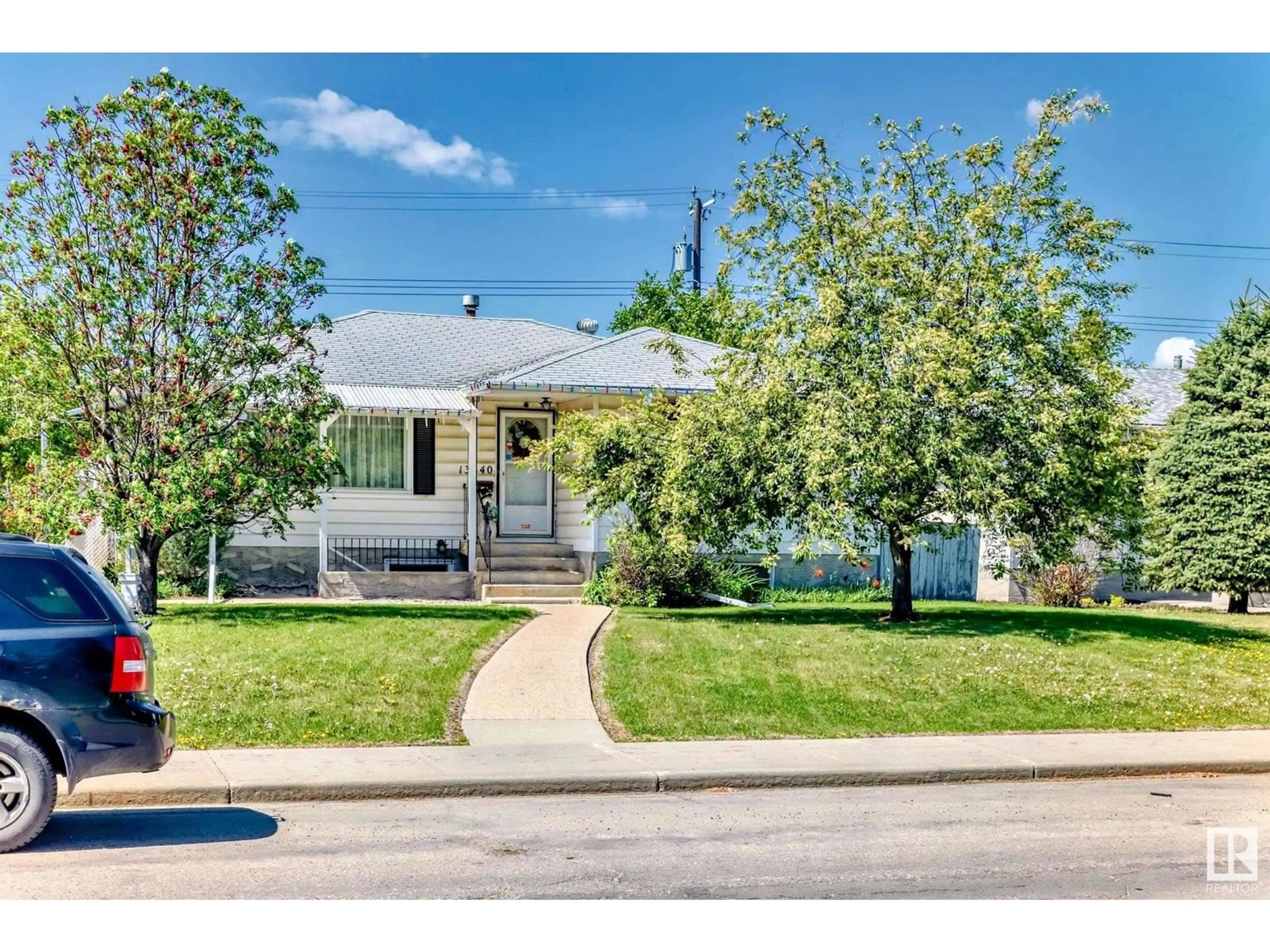 Home with vinyl exterior material, street for 13540 119 ST, Edmonton Alberta T5E5N2