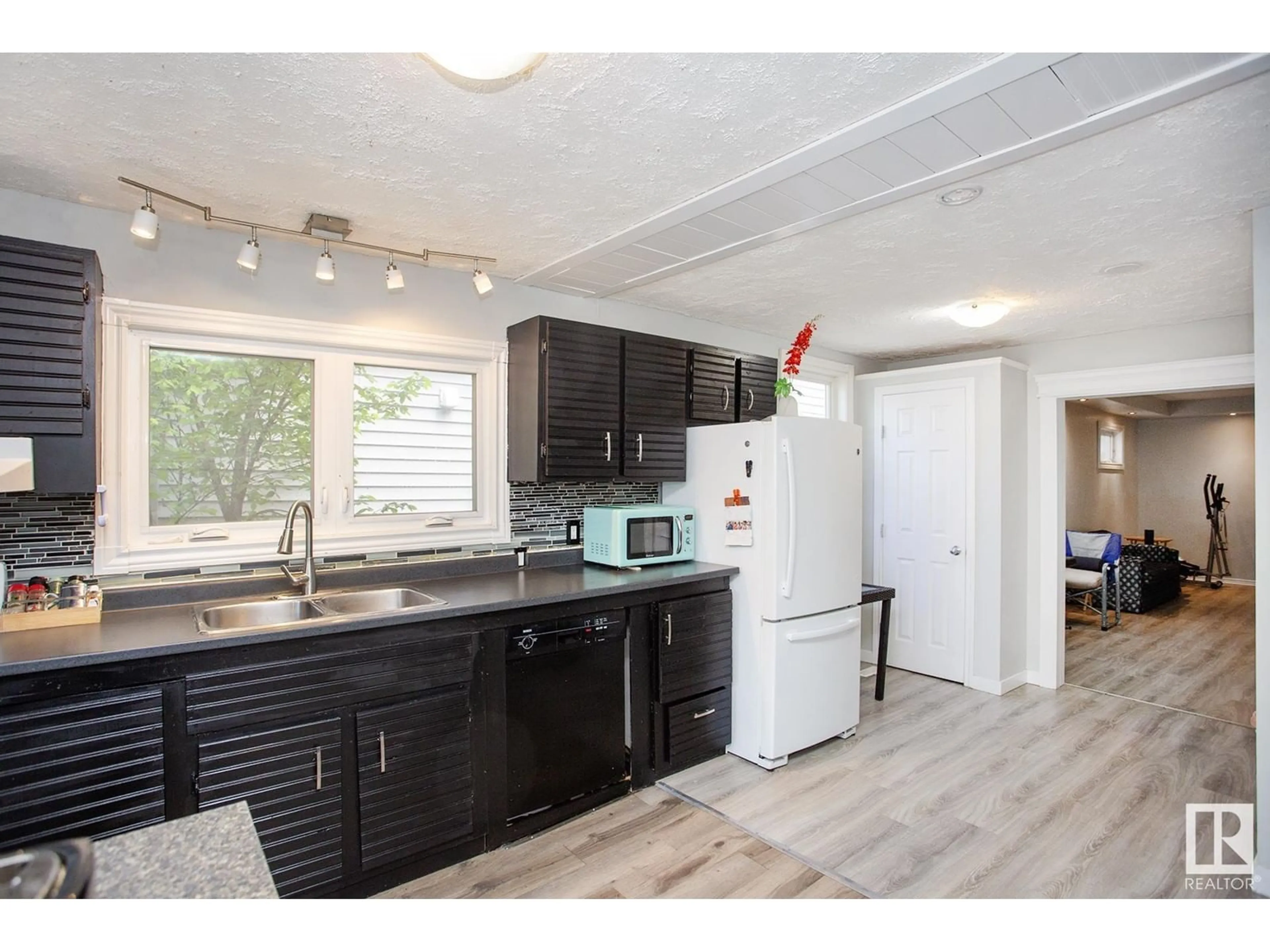 Open concept kitchen, wood/laminate floor for 11536 83 ST, Edmonton Alberta T5B2Y5