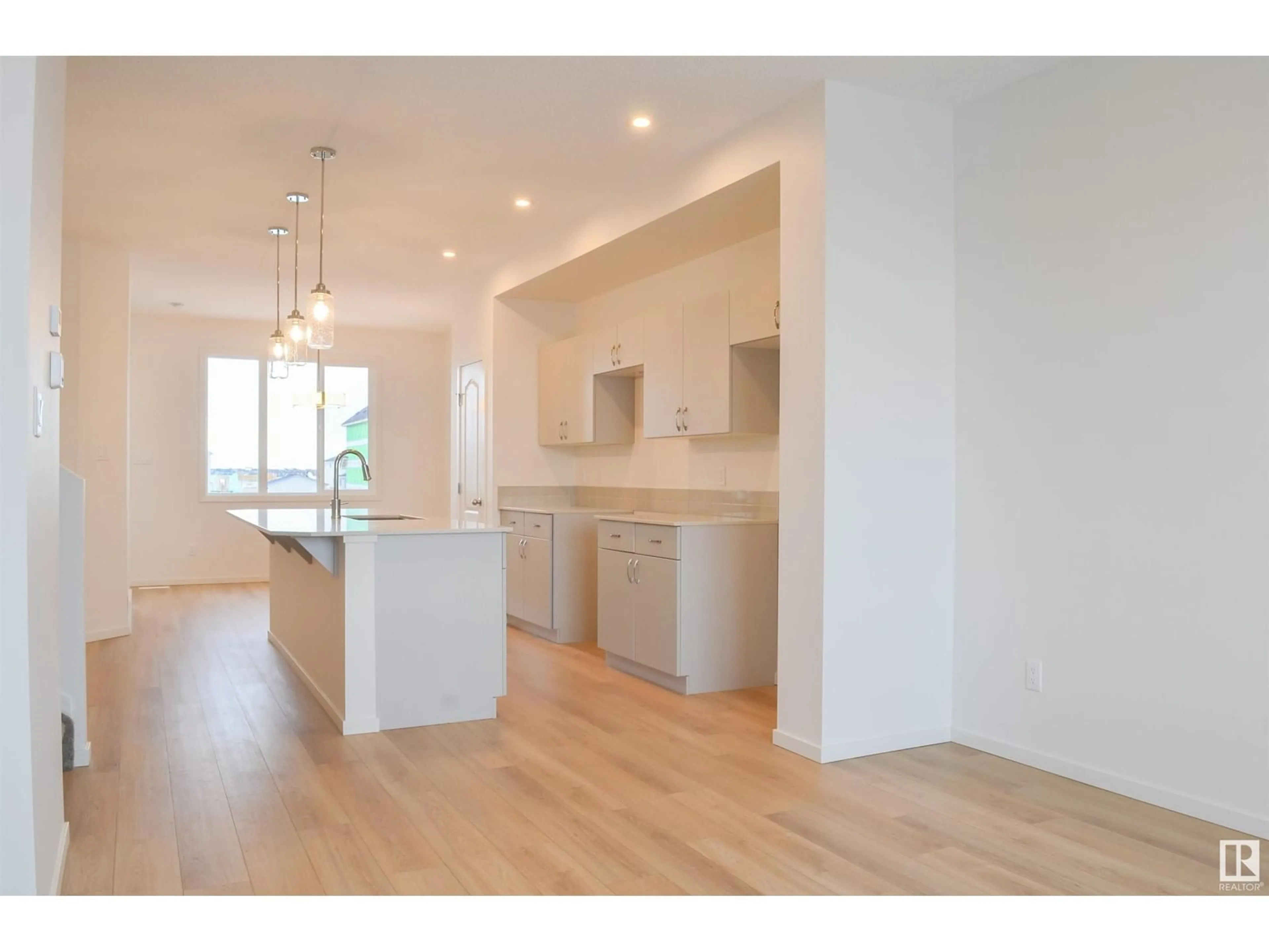 Open concept kitchen, wood/laminate floor for NW - 4611 177 AV, Edmonton Alberta T5Y4B7