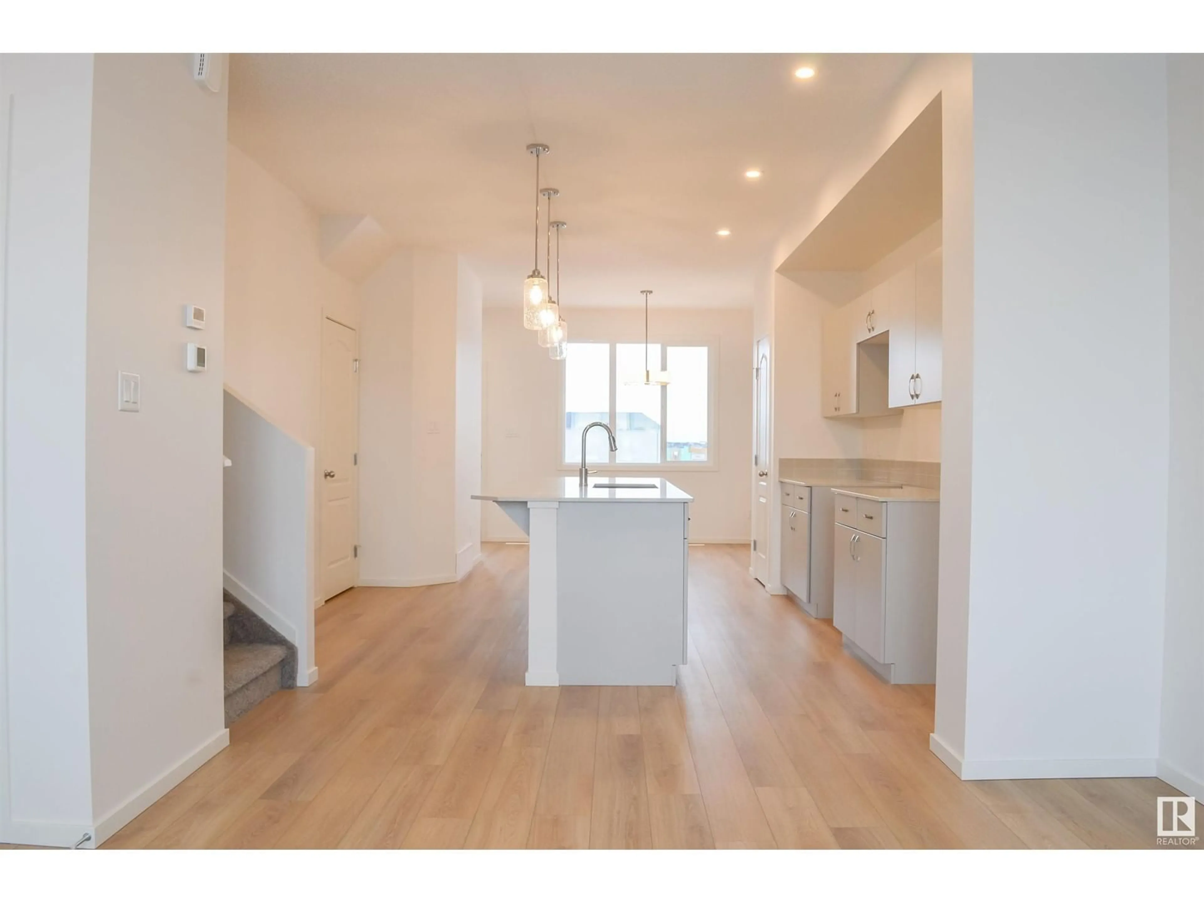 Open concept kitchen, wood/laminate floor for NW - 4611 177 AV, Edmonton Alberta T5Y4B7