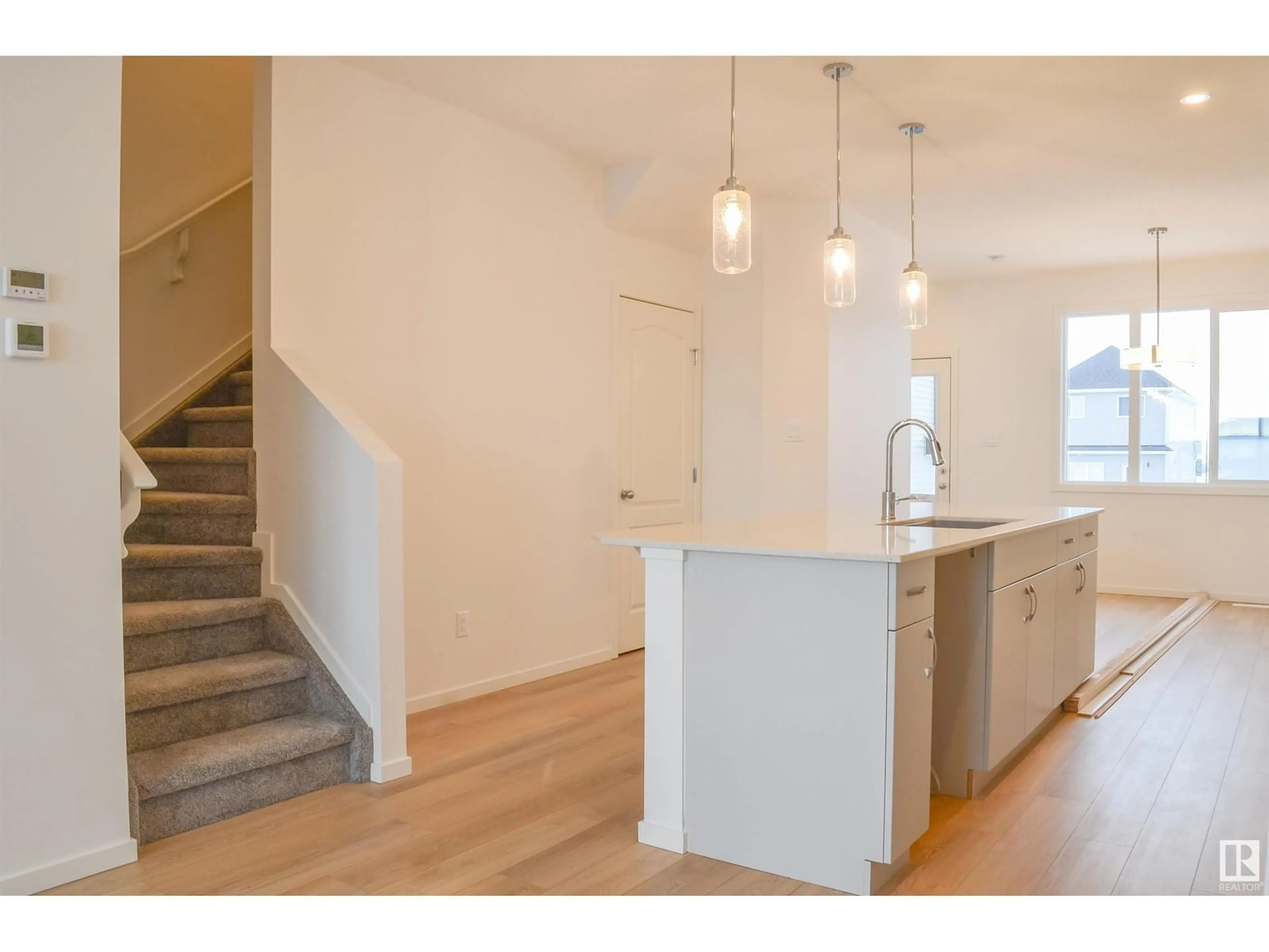 Open concept kitchen, wood/laminate floor for NW - 4611 177 AV, Edmonton Alberta T5Y4B7