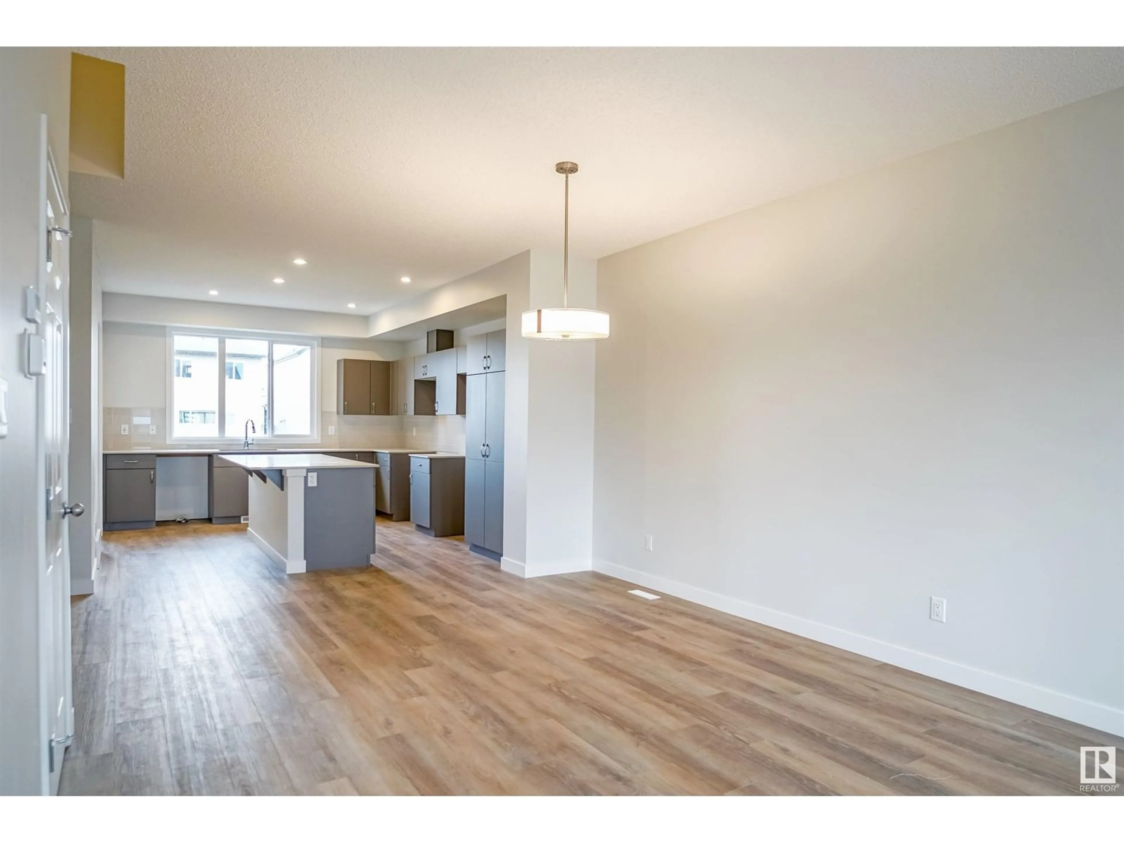 Open concept kitchen, wood/laminate floor for NW - 4615 177 AV, Edmonton Alberta T5Y4B7