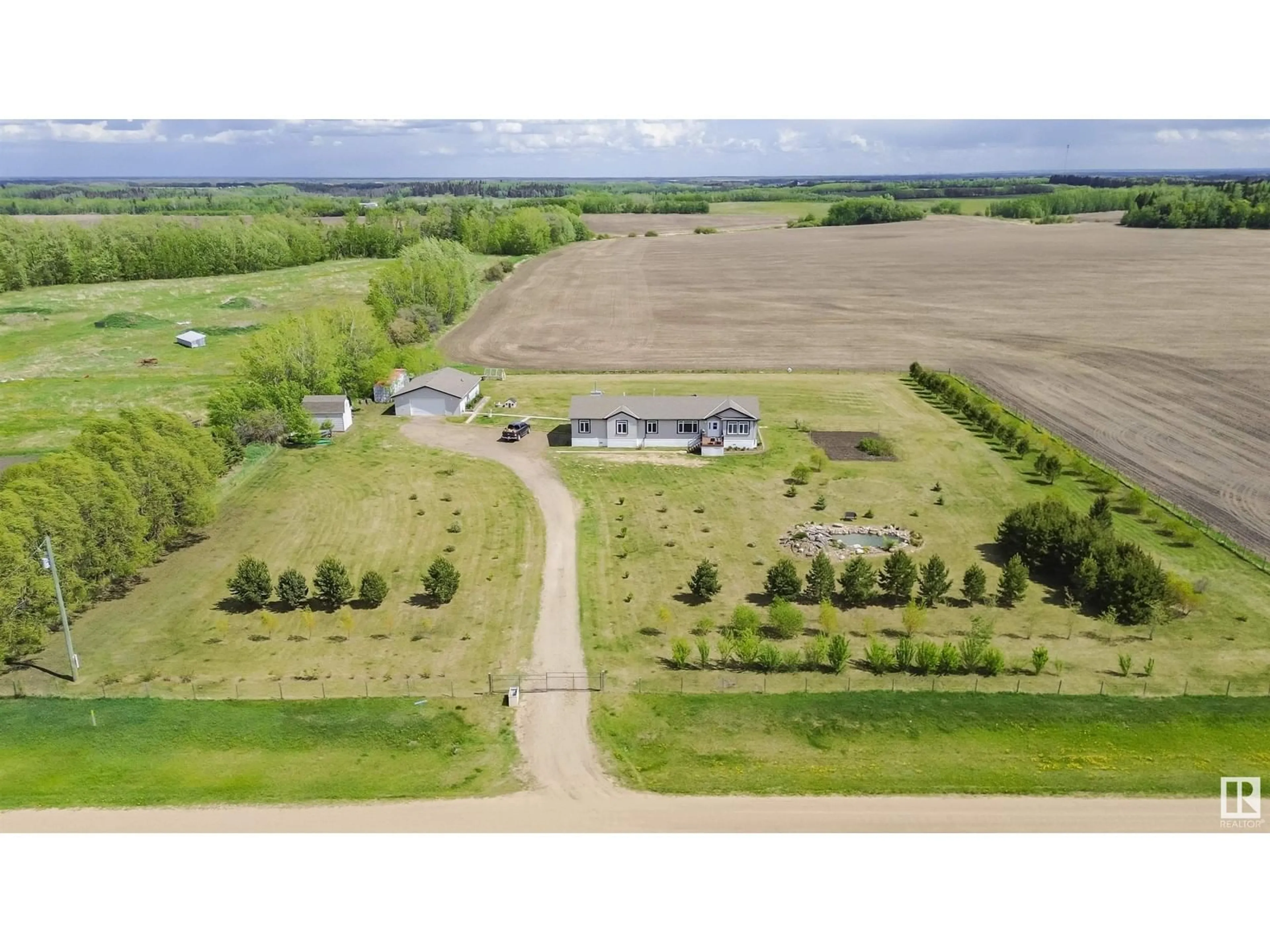A pic from outside/outdoor area/front of a property/back of a property/a pic from drone, unknown for 57015 RR 241, Rural Sturgeon County Alberta T0A0K1