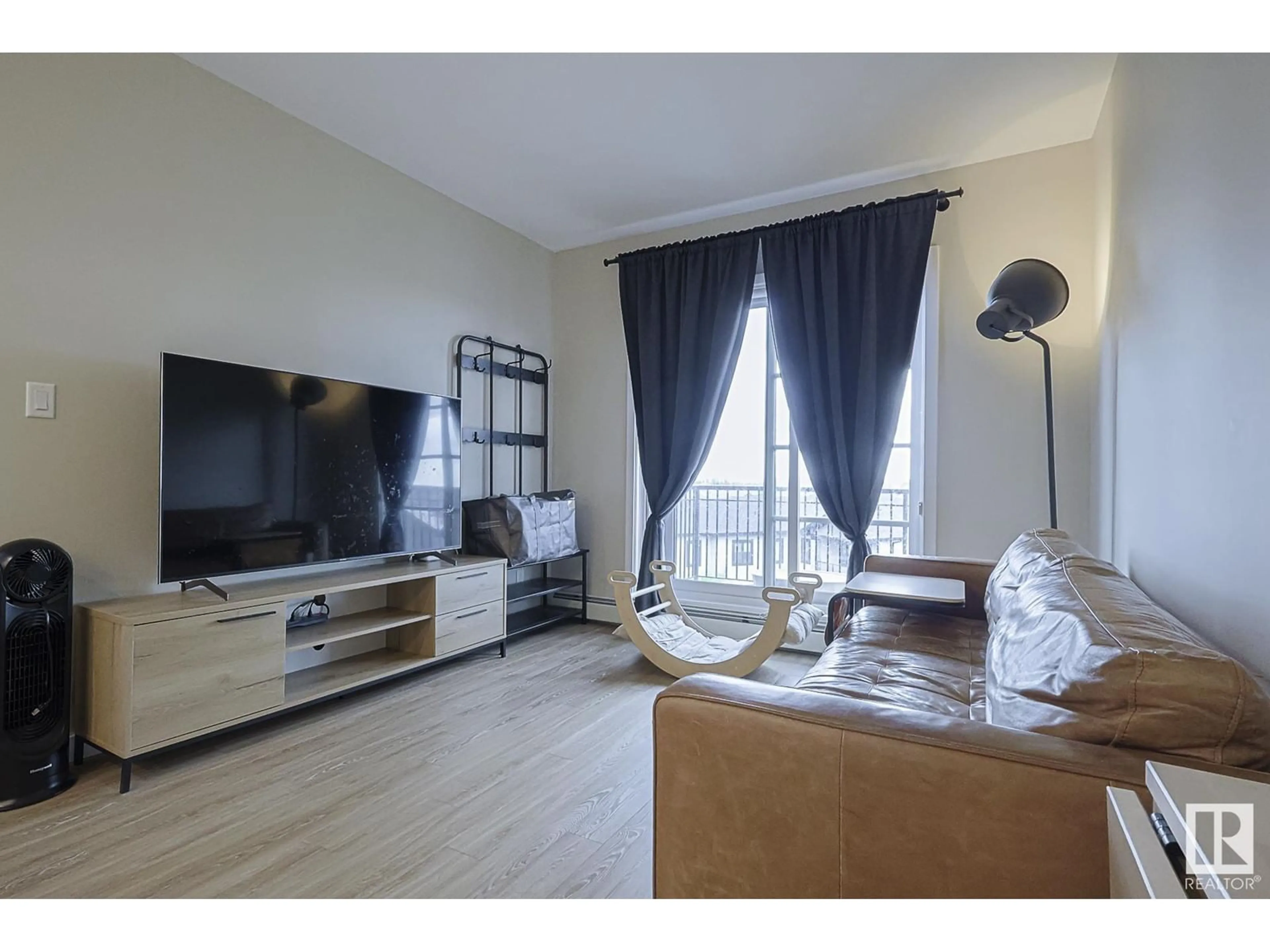 Living room with furniture, wood/laminate floor for #426 - 1154 ADAMSON DR, Edmonton Alberta T6W3N5