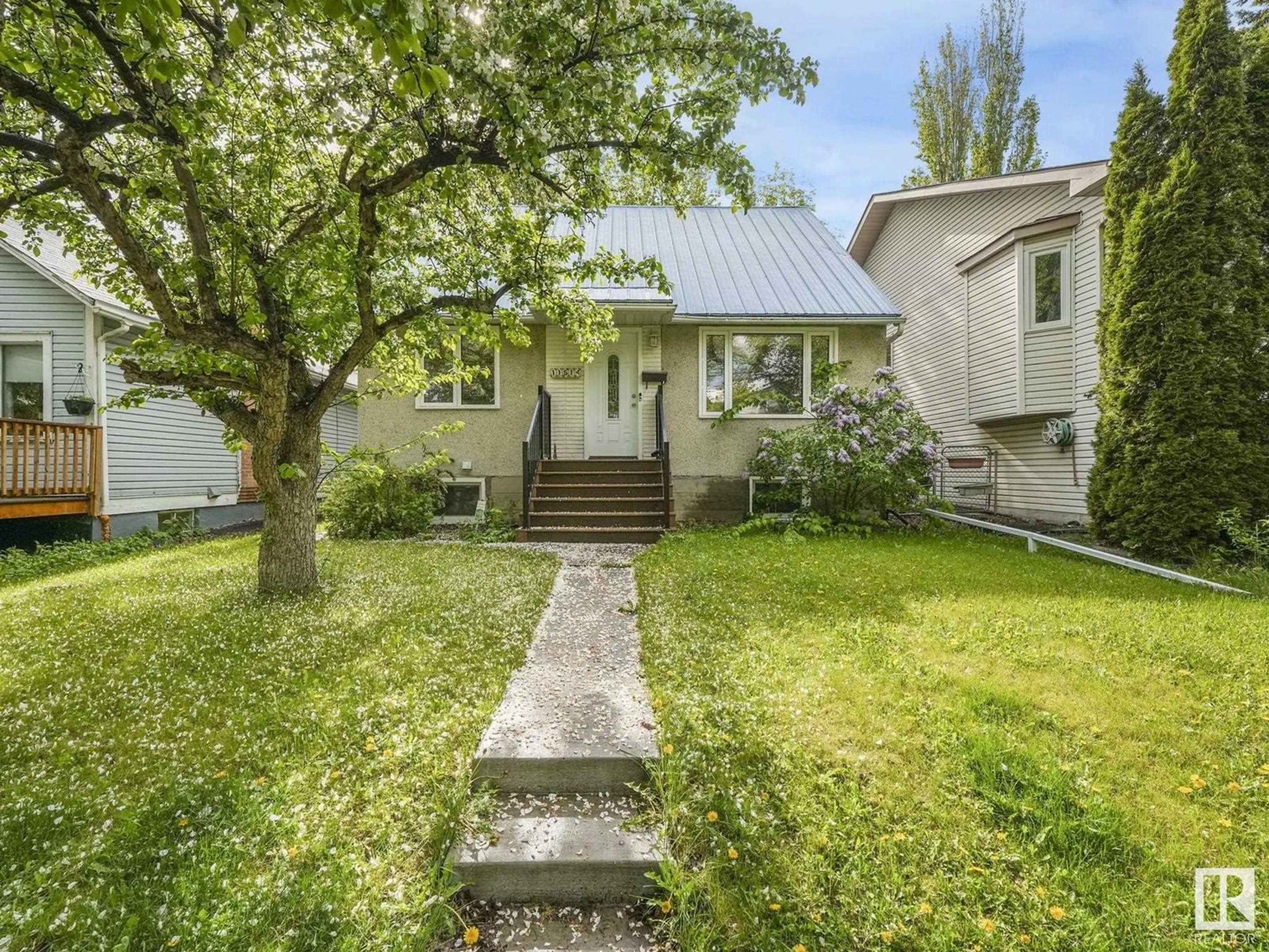 Home with vinyl exterior material, street for 11514 122 ST, Edmonton Alberta T5M0C1